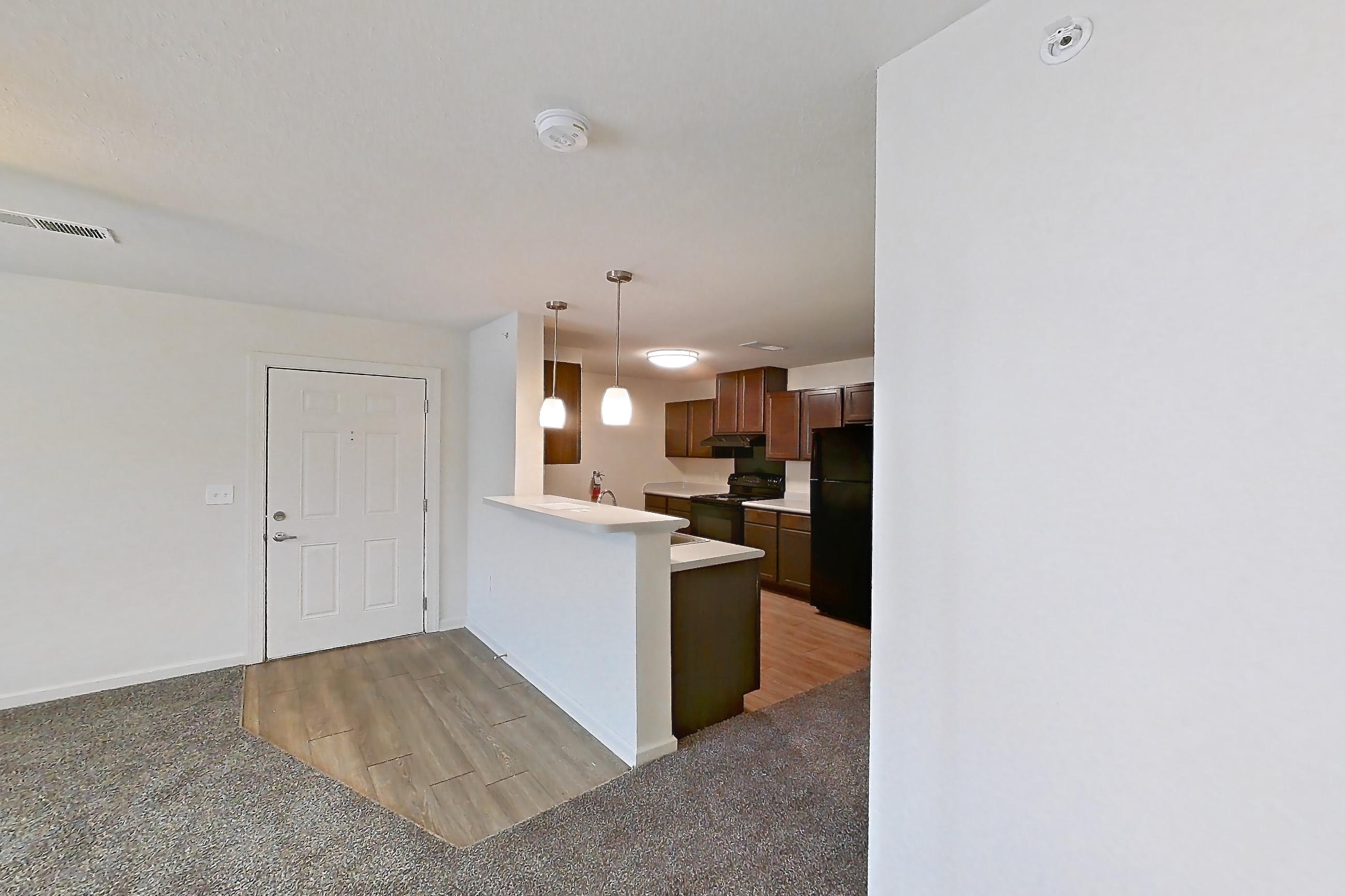 Dining room with black appliances, electric range, light countertops, light wood-finish flooring, oven/range, and refrigerator, Apartment 4L at Springbrook