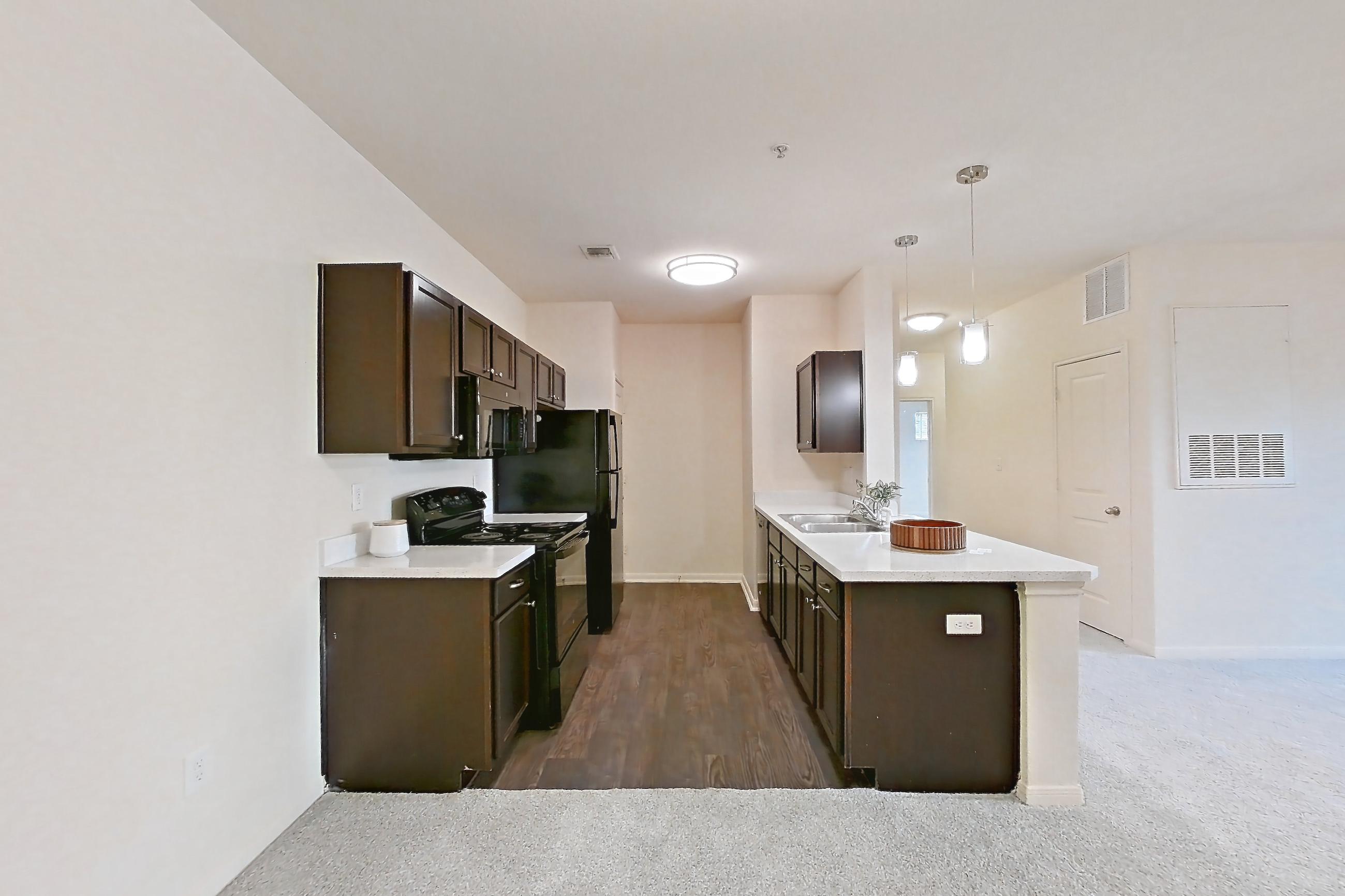 Dining area with black appliances, dark carpet, electric range, light countertops, oven/range, and refrigerator, Apartment 1232 at William Cannon