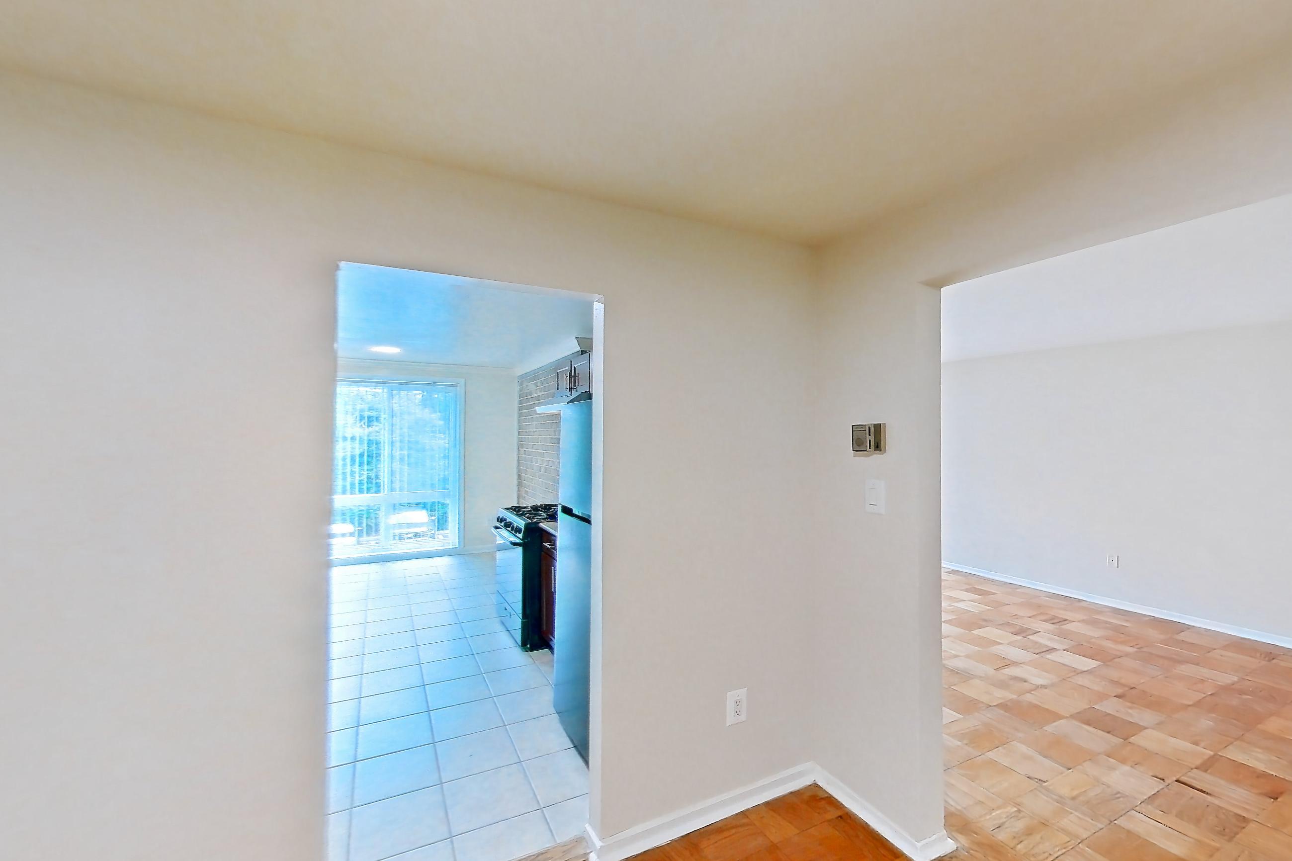 Dining room with gas range, light wood-finish flooring, parquet flooring, refrigerator, and stainless steel appliances, Apartment 9320ER24 at Franklin Park at Greenbelt Station