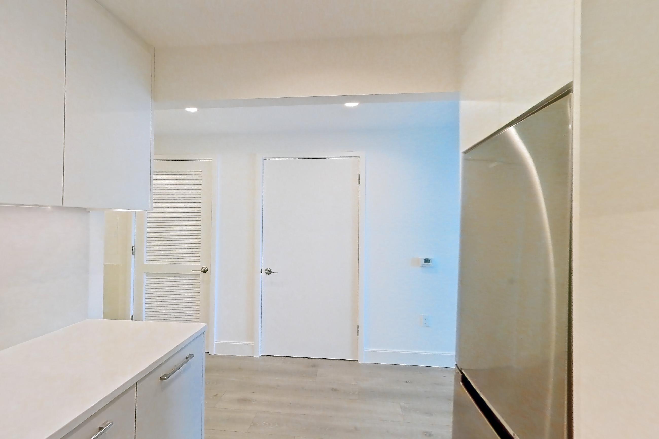 Kitchen with dishwasher, gas range, light countertops, light stone countertops, light wood-finish flooring, oven/range, refrigerator, and stainless steel appliances, Apartment 37L at Lumen