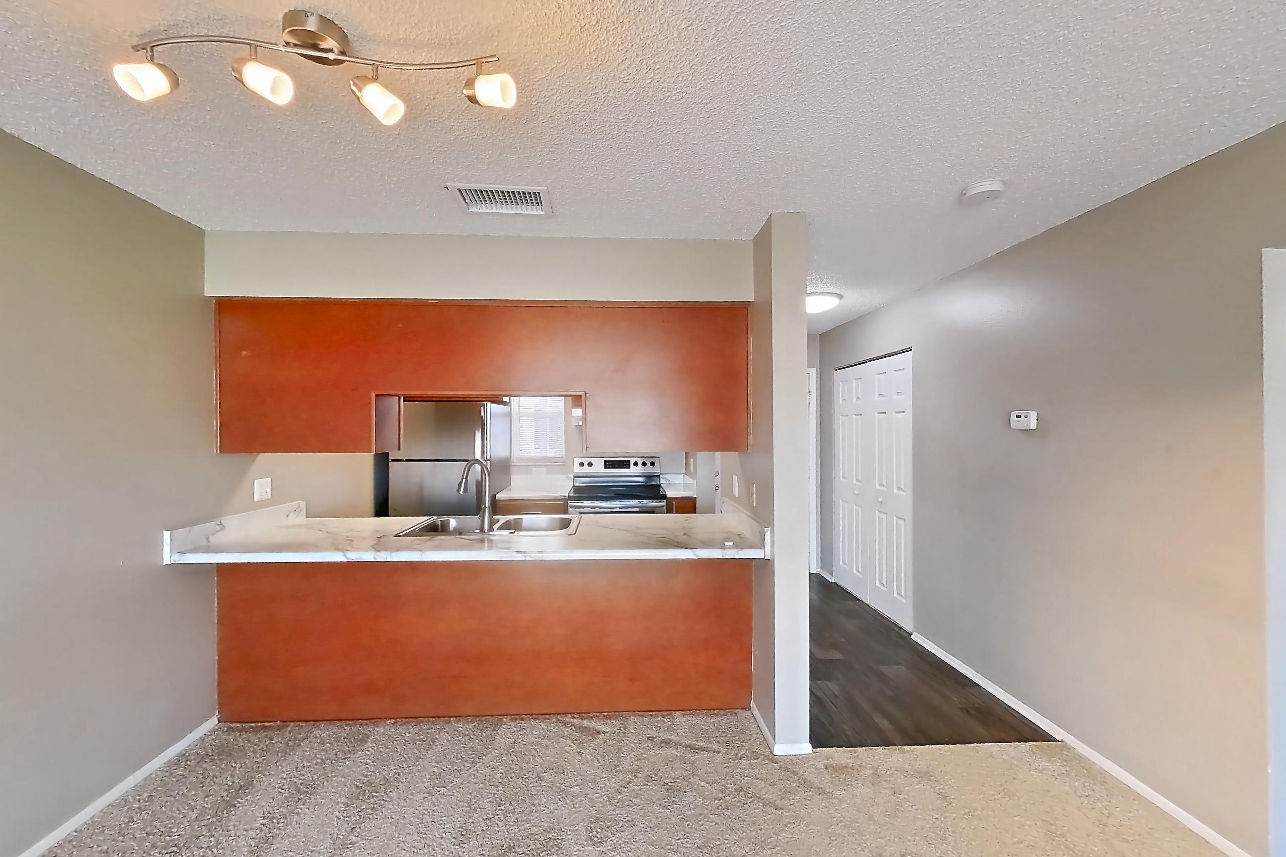 Living space with electric range, oven/range, refrigerator, and stainless steel appliances, Apartment 4060 Unit 11 at Aaron Lake Apartments