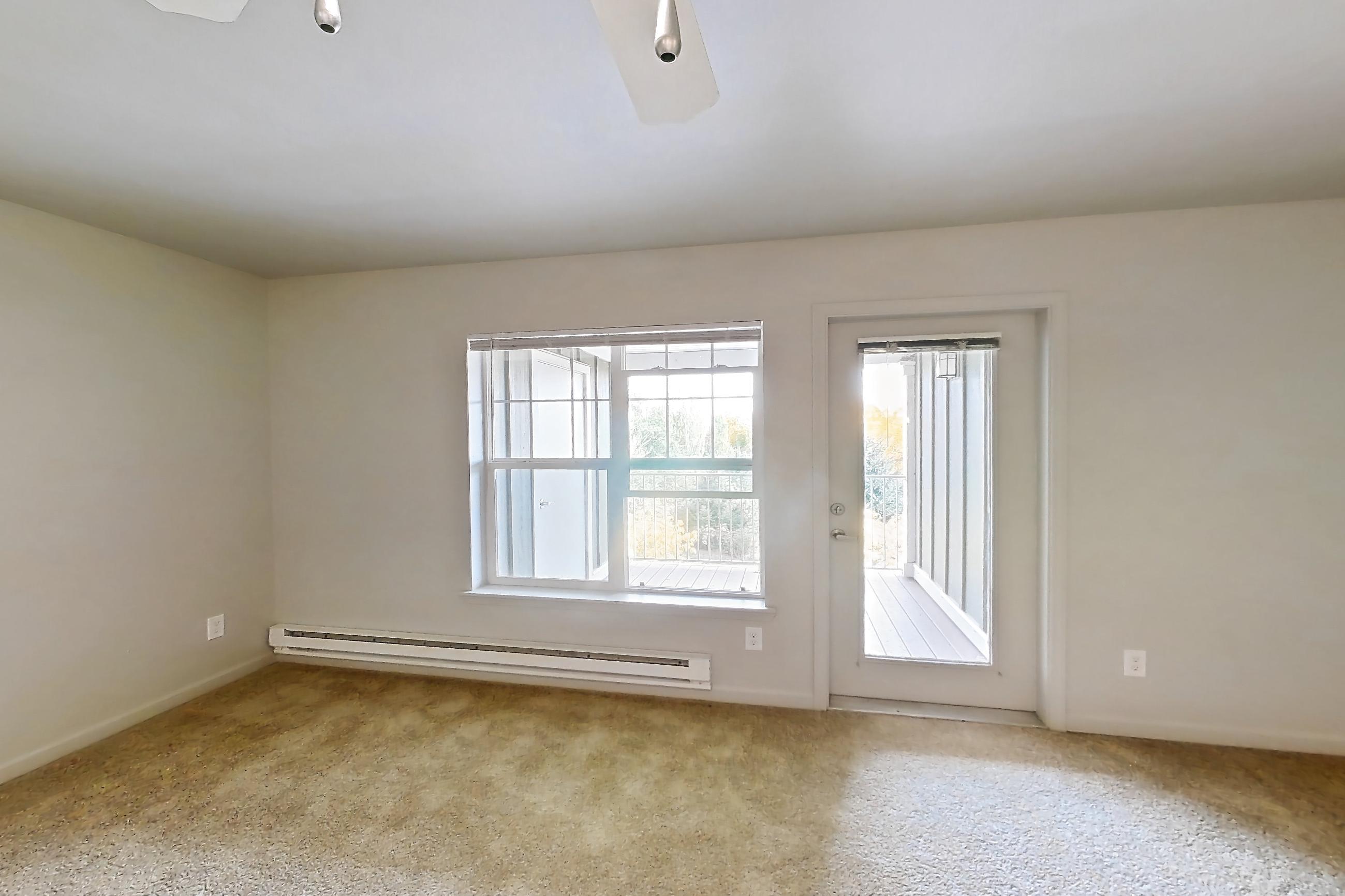Living room with baseboard heating, Apartment 111 at Sunset View