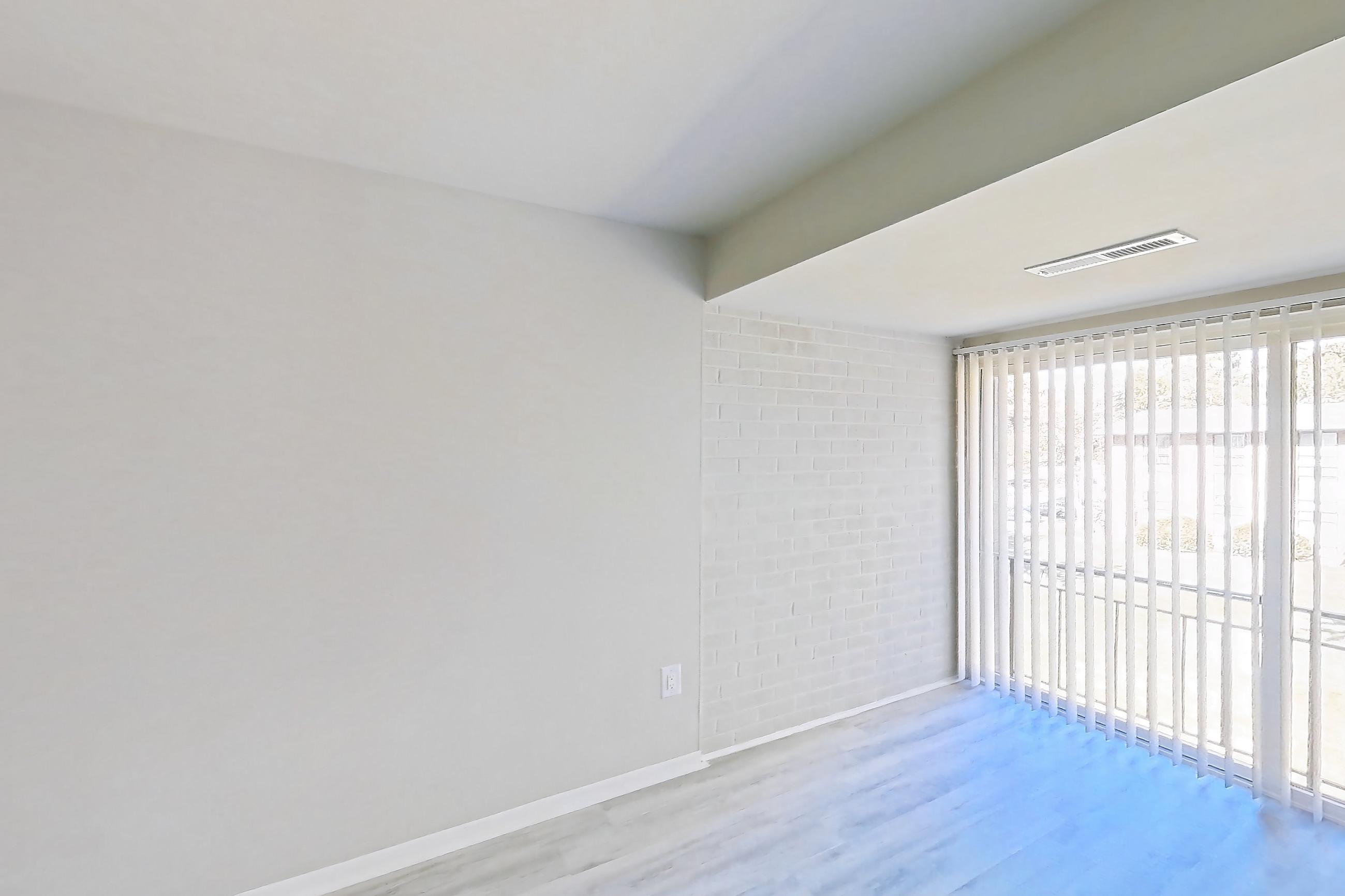 Living room with light wood-finish flooring, Apartment 5807CL31 at Franklin Park at Greenbelt Station