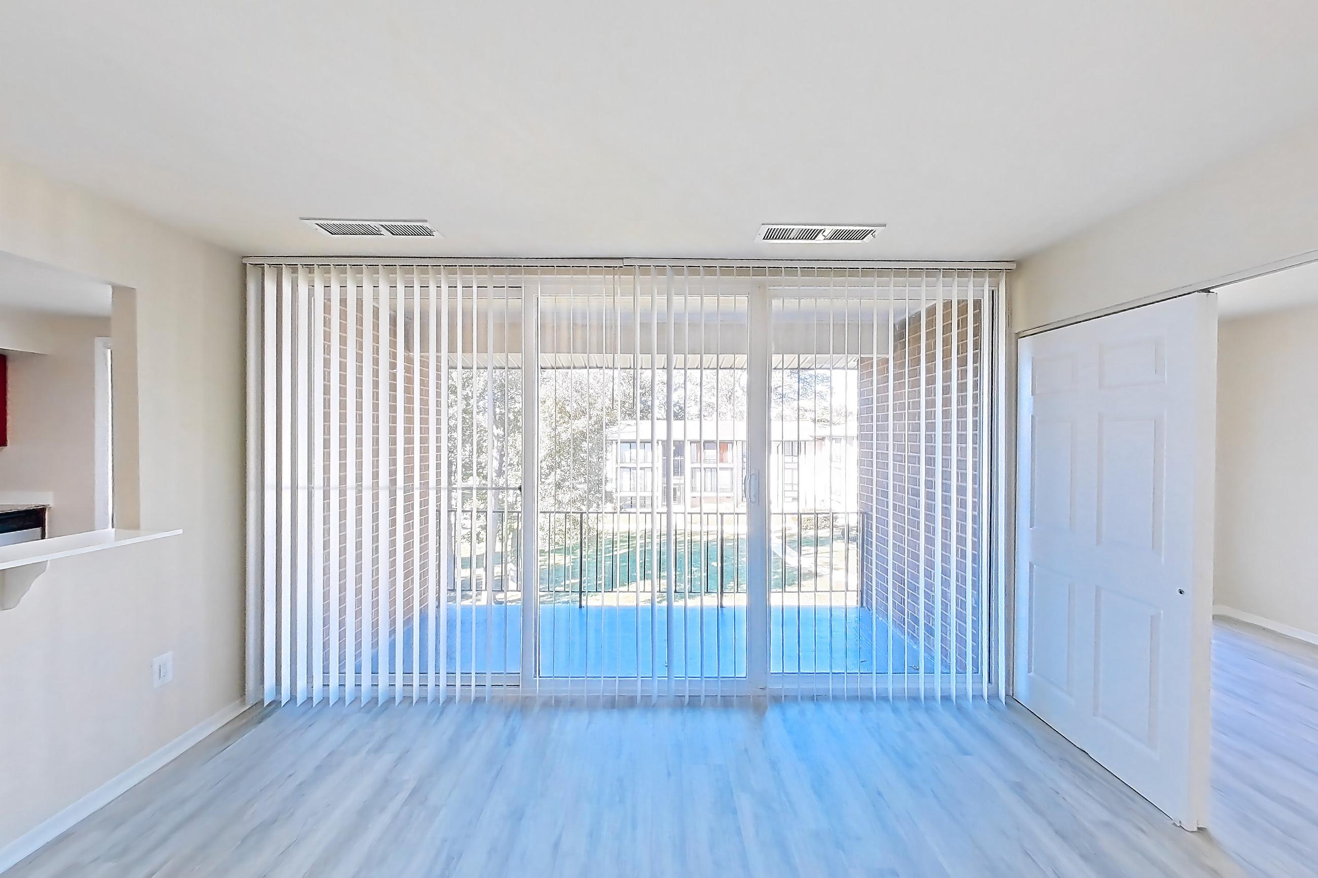 Living room with light wood-finish flooring, Apartment 5807CT32 at Franklin Park at Greenbelt Station