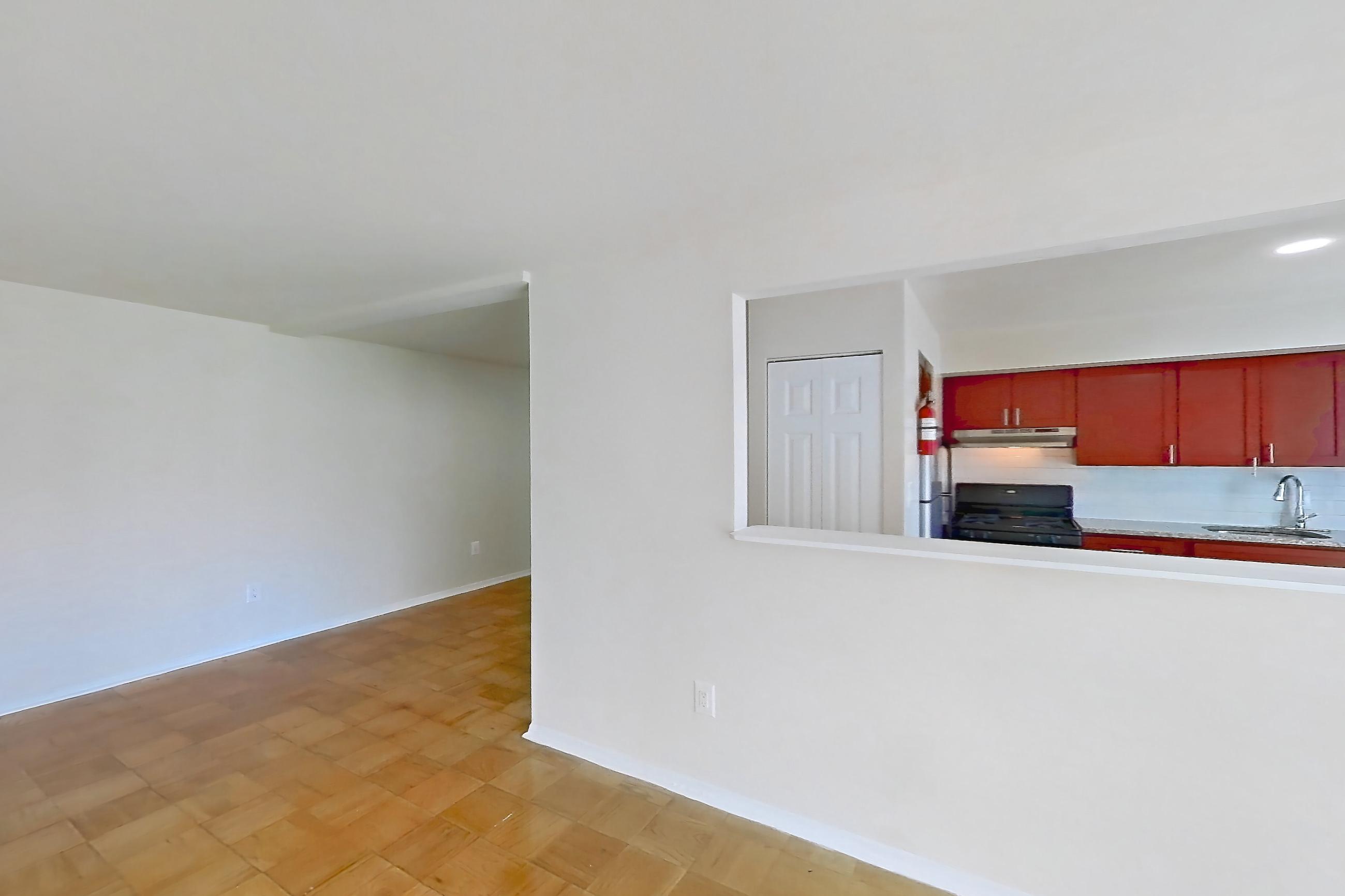 Living room with black appliances, gas range, light wood-finish flooring, oven/range, and parquet flooring, Apartment 5809CT24 at Franklin Park at Greenbelt Station