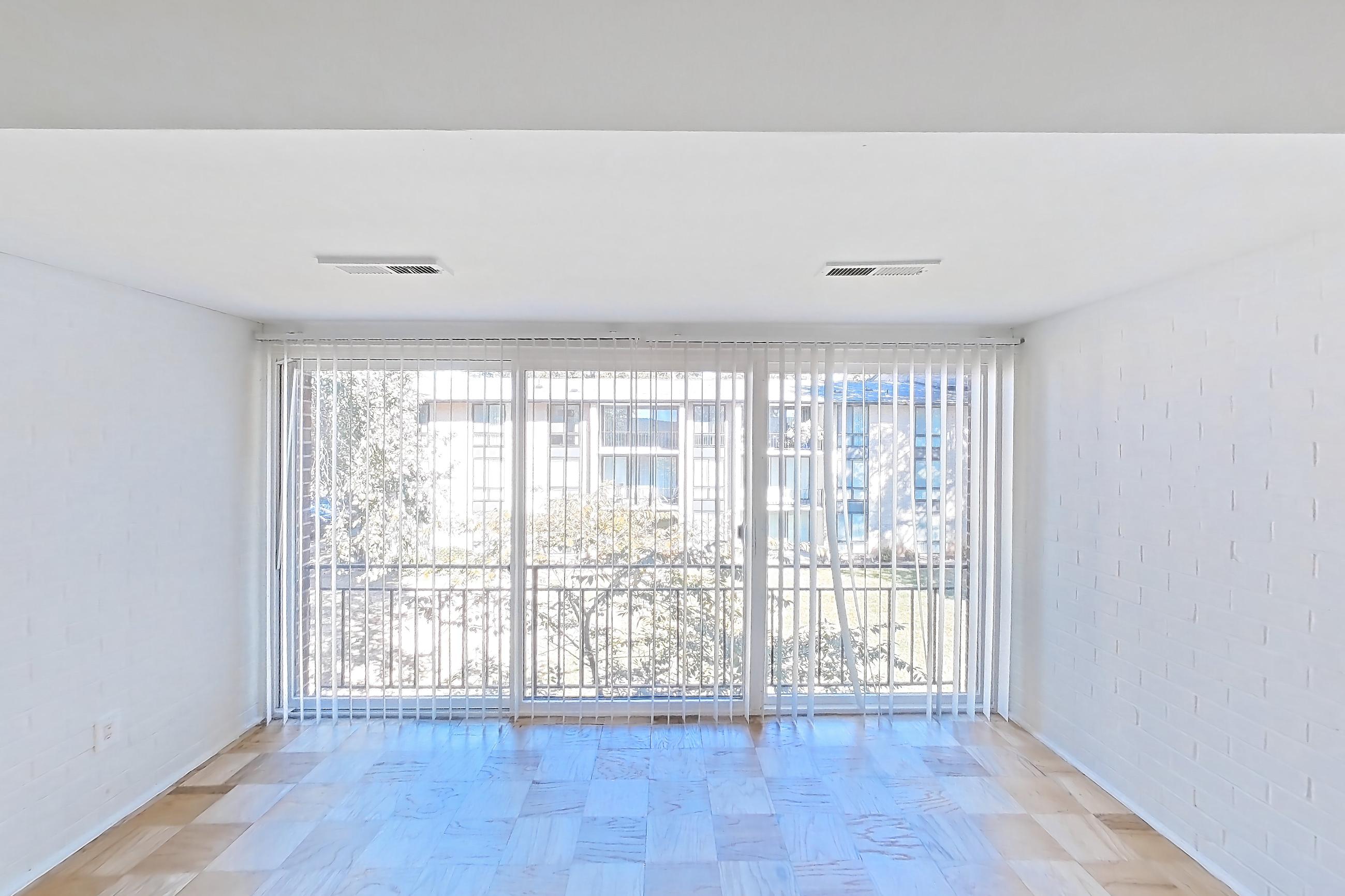 Living room with light wood-finish flooring and parquet flooring, Apartment 5811CL34 at Franklin Park at Greenbelt Station