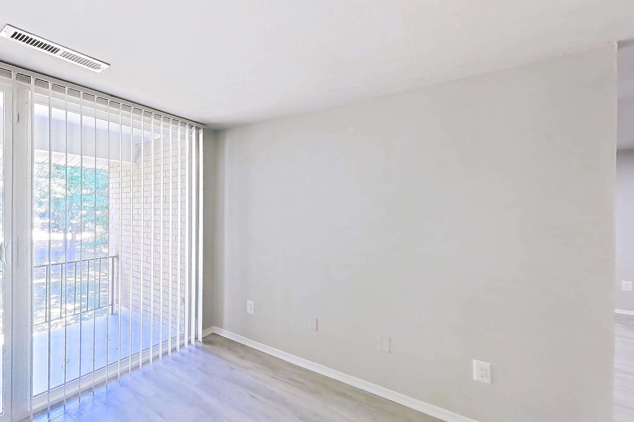 Living room with light wood-finish flooring, Apartment 5811CT33 at Franklin Park at Greenbelt Station