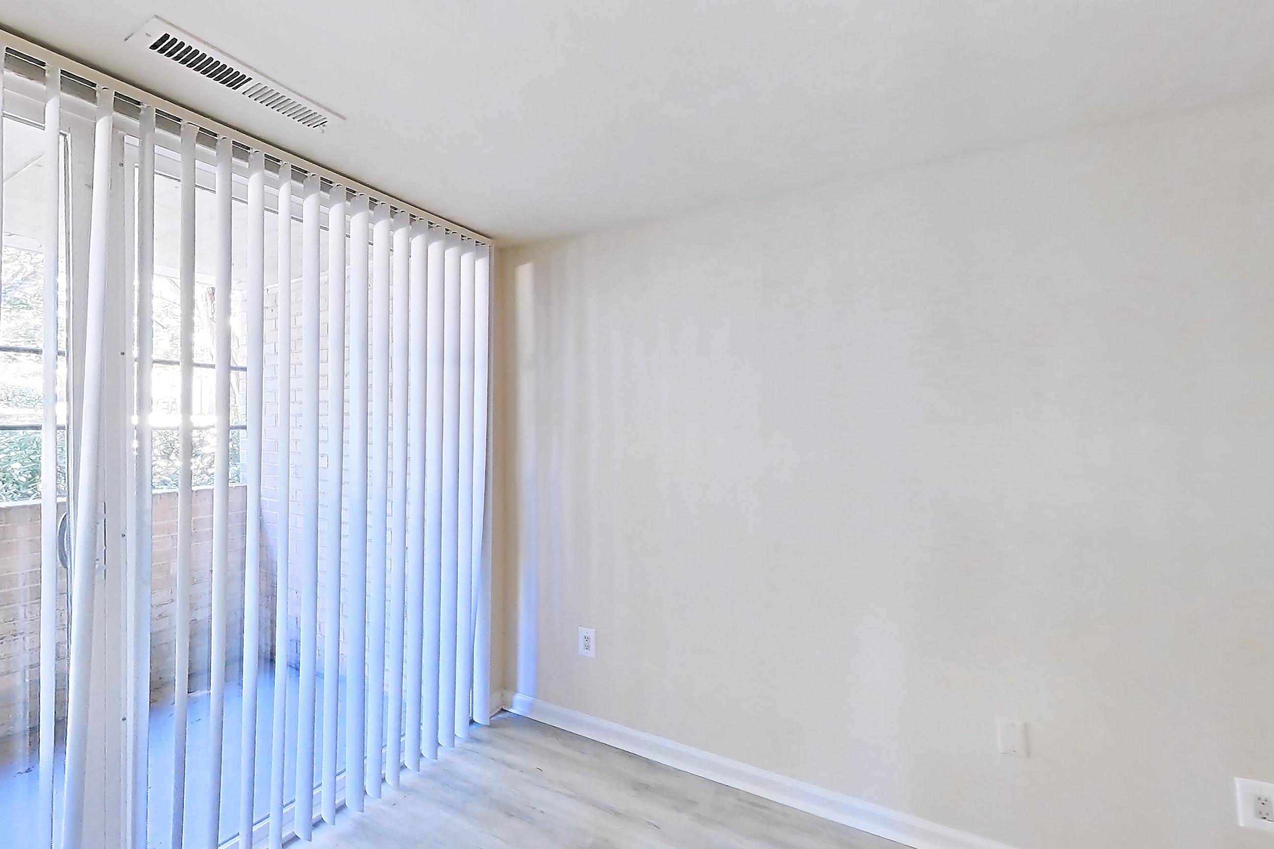 Living room with light wood-finish flooring, Apartment 5819CL11 at Franklin Park at Greenbelt Station