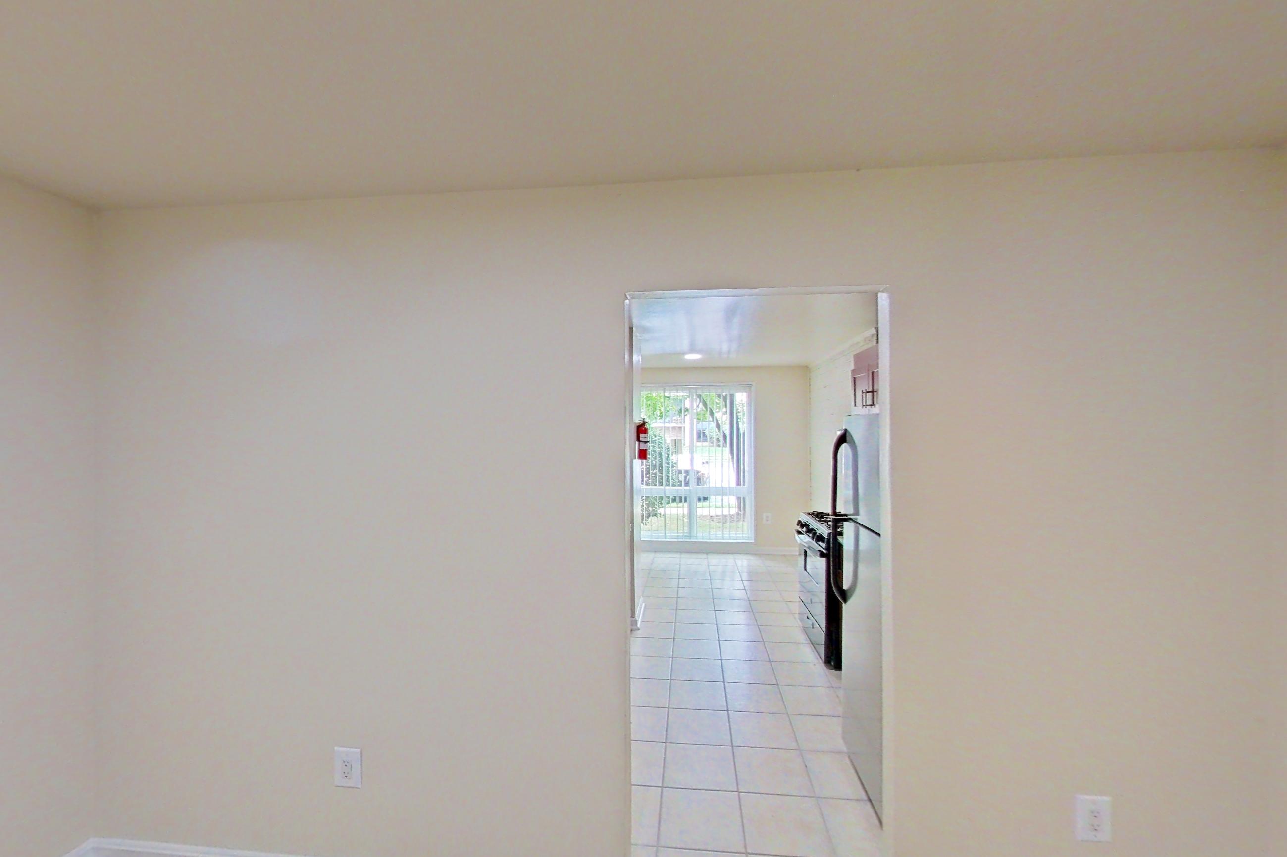 Dining room with black appliances, dark wood-finish flooring, gas range, light wood-finish flooring, oven/range, refrigerator, white appliances, and wood-look tile flooring, Apartment 9326ER12 at Franklin Park at Greenbelt Station