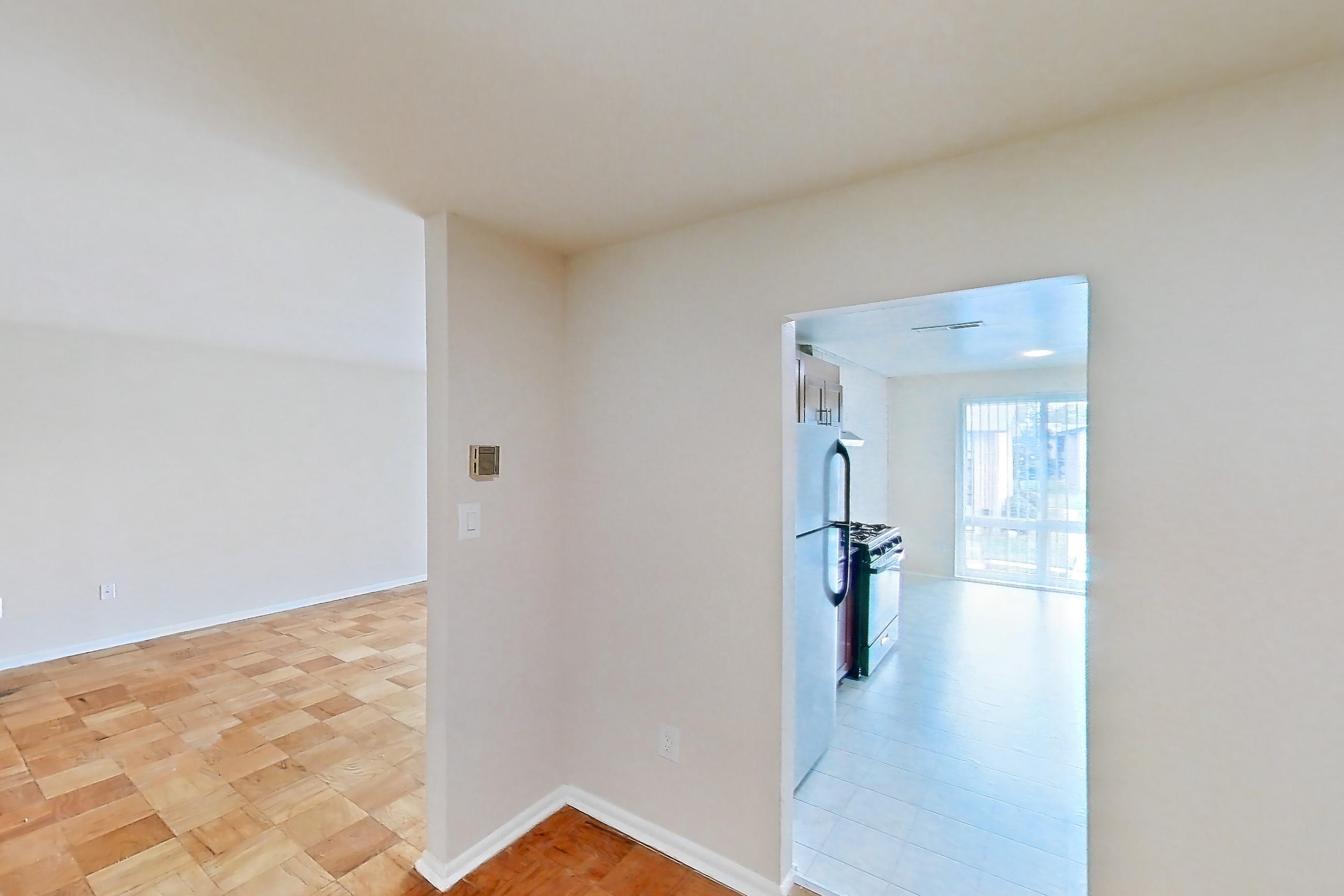 Dining room with gas range, light wood-finish flooring, parquet flooring, refrigerator, and white appliances, Apartment 9328ER31 at Franklin Park at Greenbelt Station