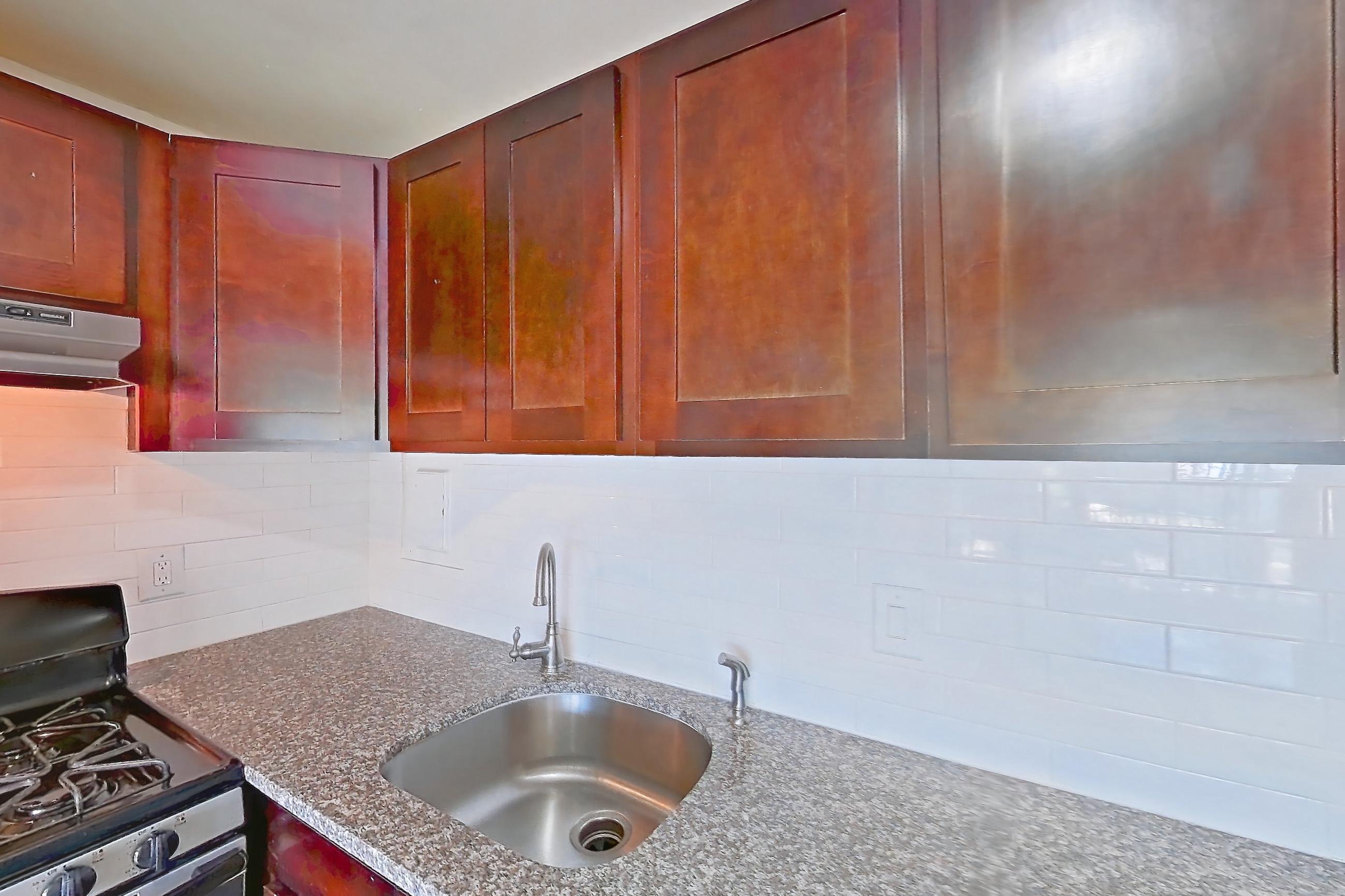 Kitchen in a Rexford floor plan apartment, representative of Apartment 6202BD23 at Franklin Park at Greenbelt Station