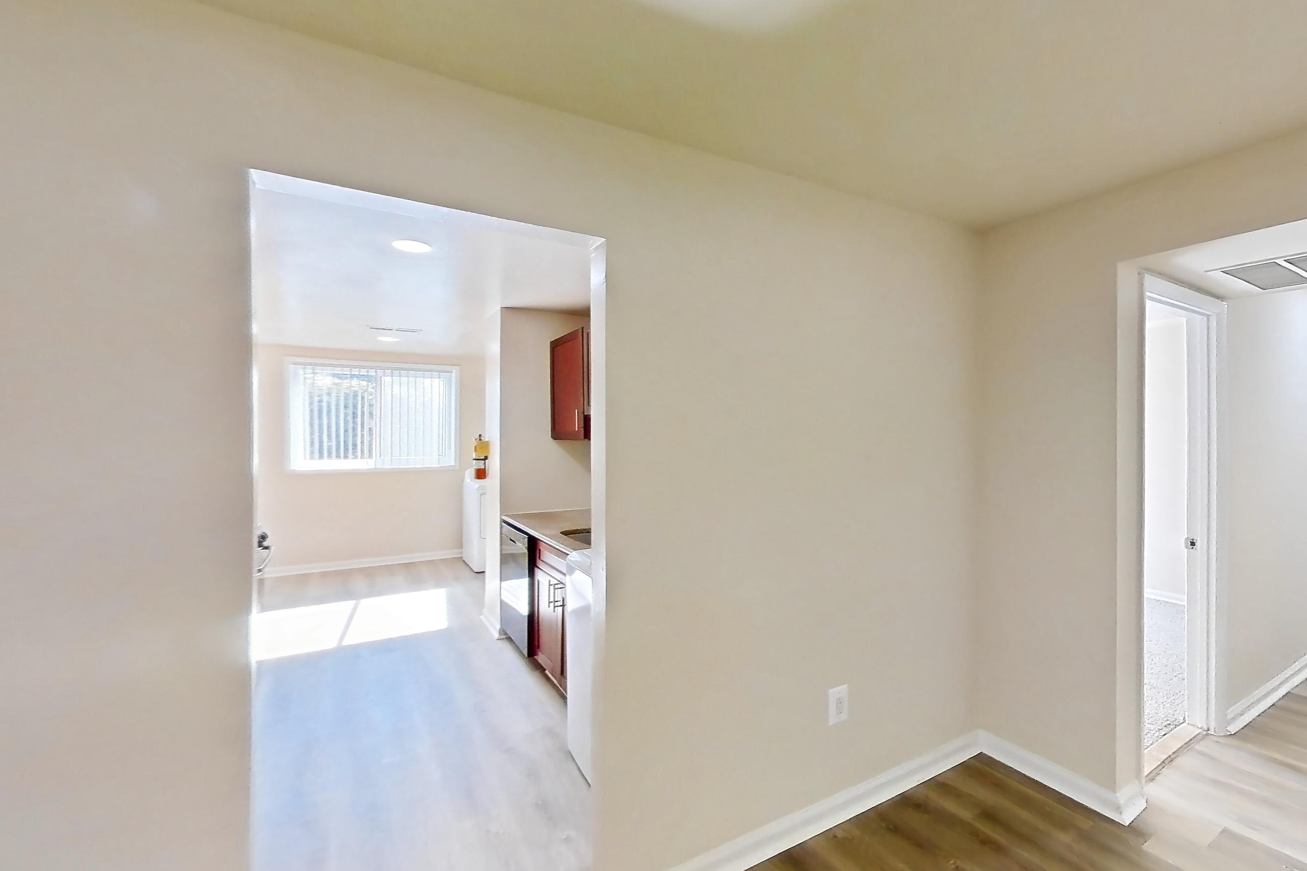 Dining room with dishwasher, light wood-finish flooring, and stainless steel appliances, Apartment 9000BT11 at Franklin Park at Greenbelt Station