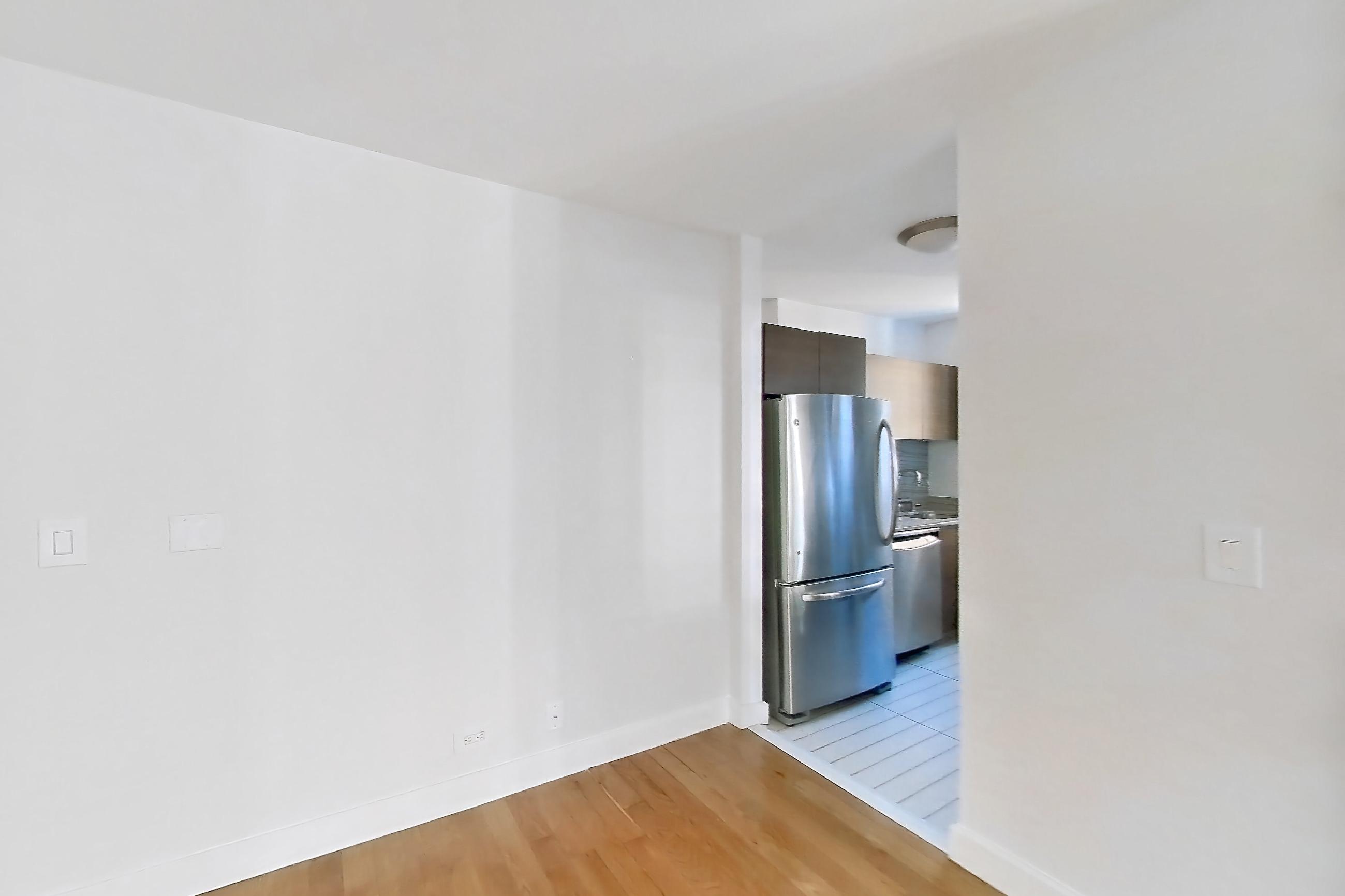 Living room with dishwasher, light wood-finish flooring, refrigerator, stainless steel appliances, and wood-finish flooring, Apartment 10M at Stonehenge Leasing