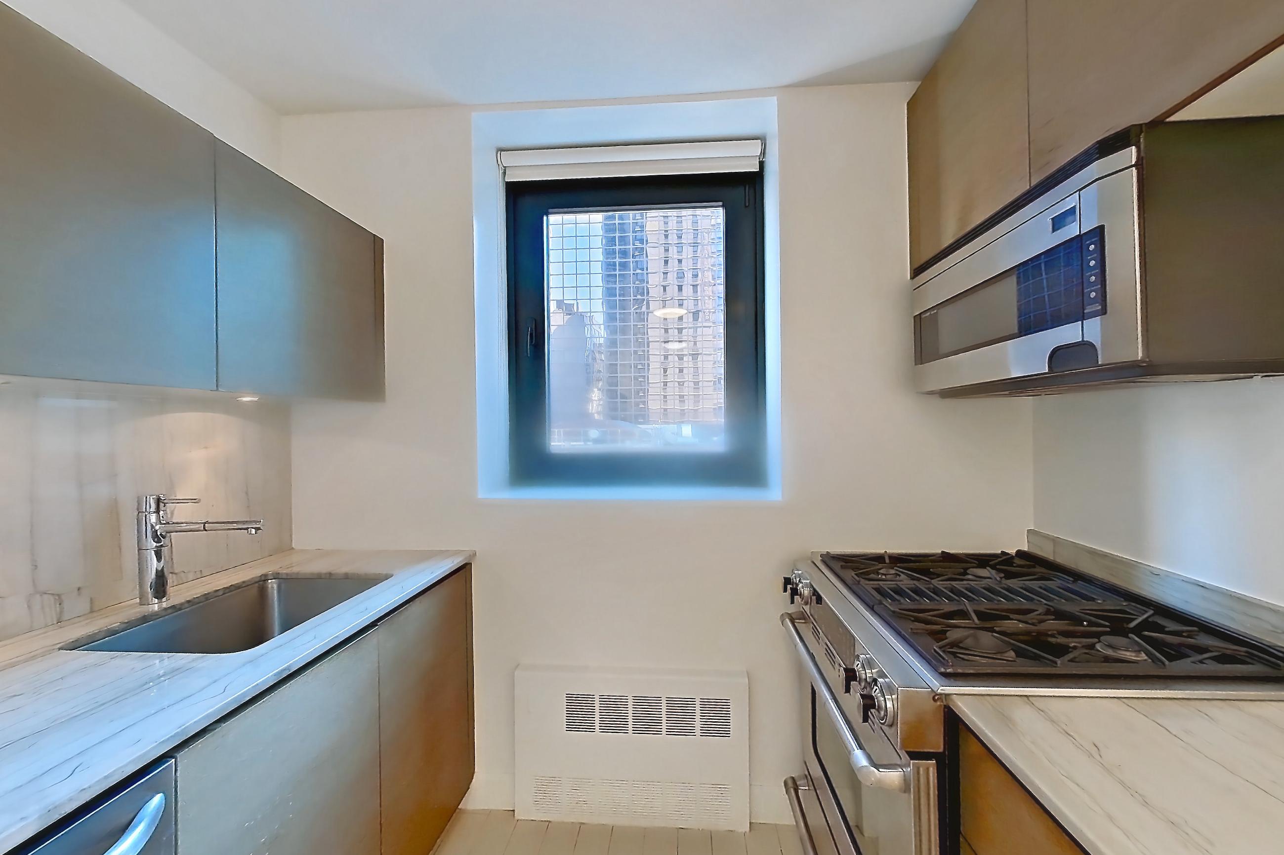 Kitchen with dishwasher, gas range, light countertops, light stone countertops, light tile flooring, oven/range, and stainless steel appliances, Apartment 22C at Stonehenge Leasing