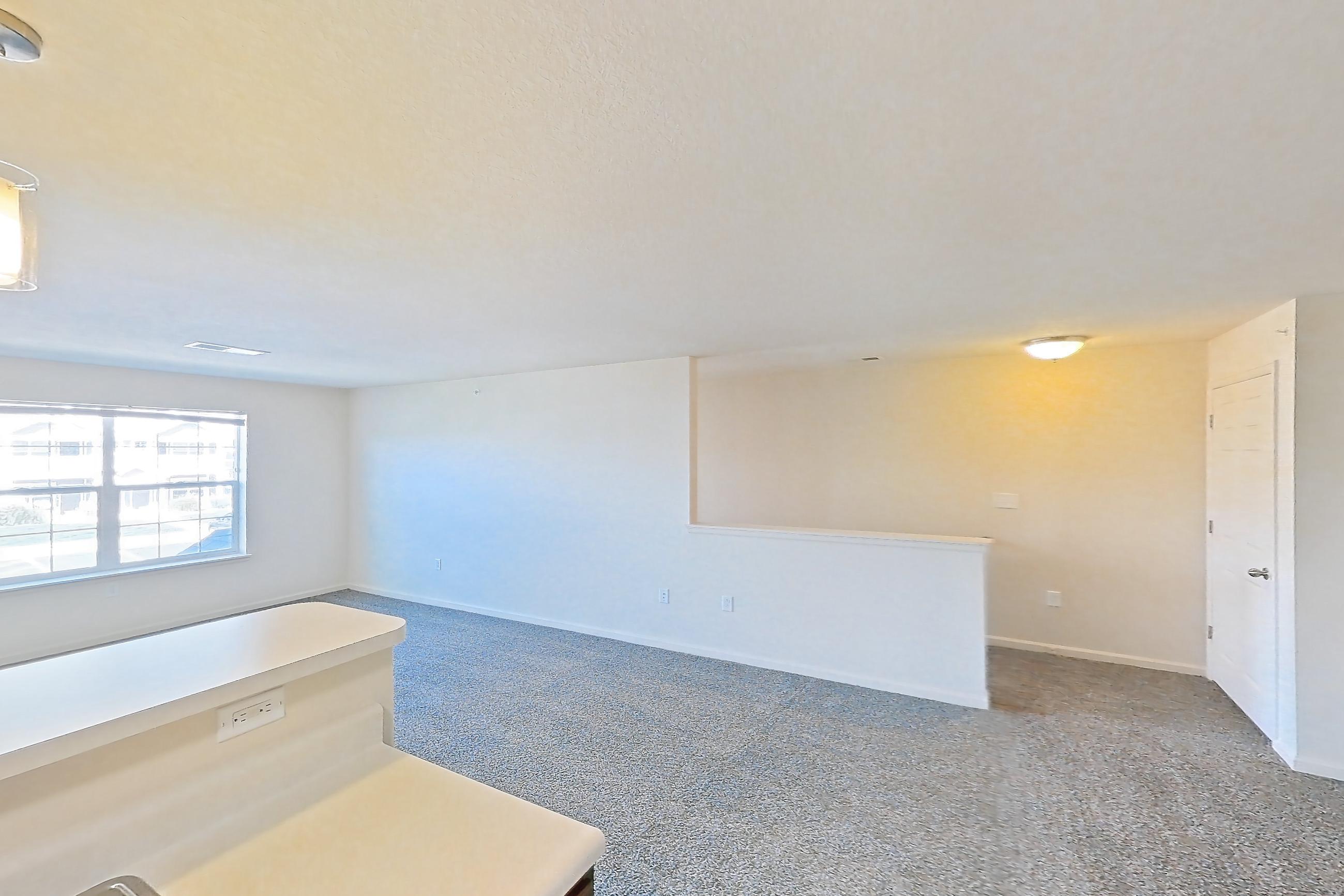 Kitchen with dark carpet, dark wood-finish flooring, dishwasher, electric range, light countertops, oven/range, range hood, refrigerator, and white appliances, Apartment 6421-206 at Ashley Estates