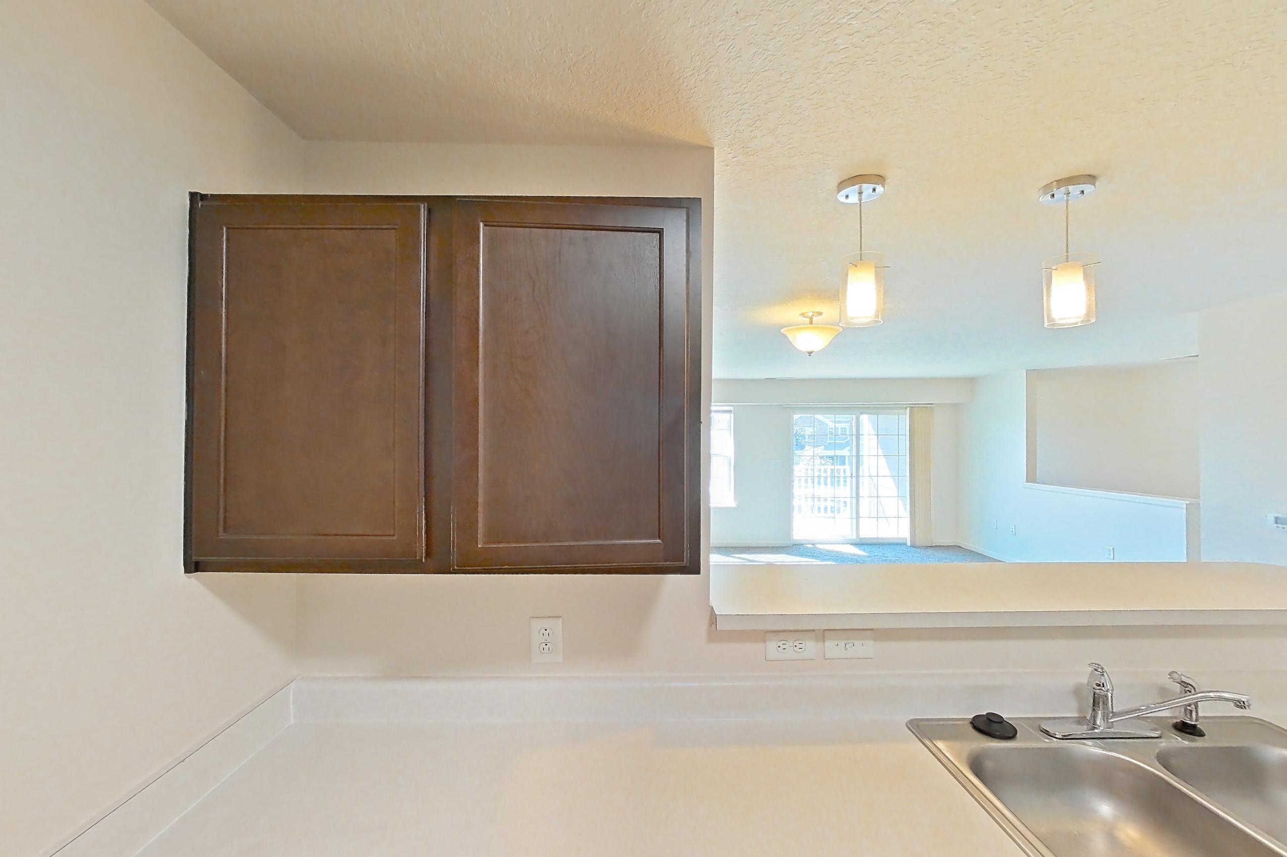 Kitchen with dark wood-finish flooring, dishwasher, electric range, light countertops, oven/range, refrigerator, and white appliances, Apartment 6469-206 at Ashley Estates