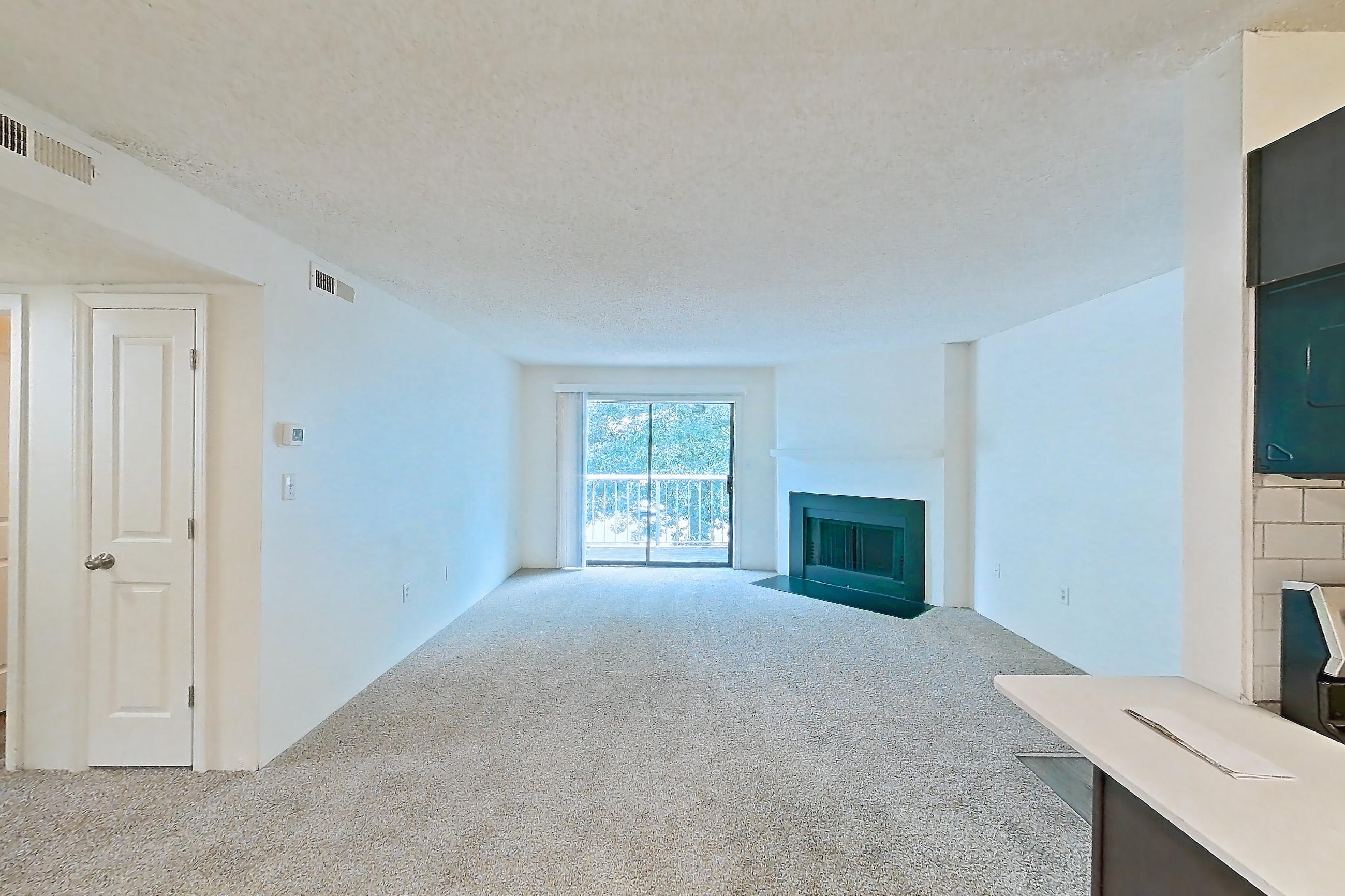Dining room with electric range, fireplace, light carpet, light countertops, light stone countertops, light wood-finish flooring, oven/range, and stainless steel appliances, Apartment 61302 at The Boulders