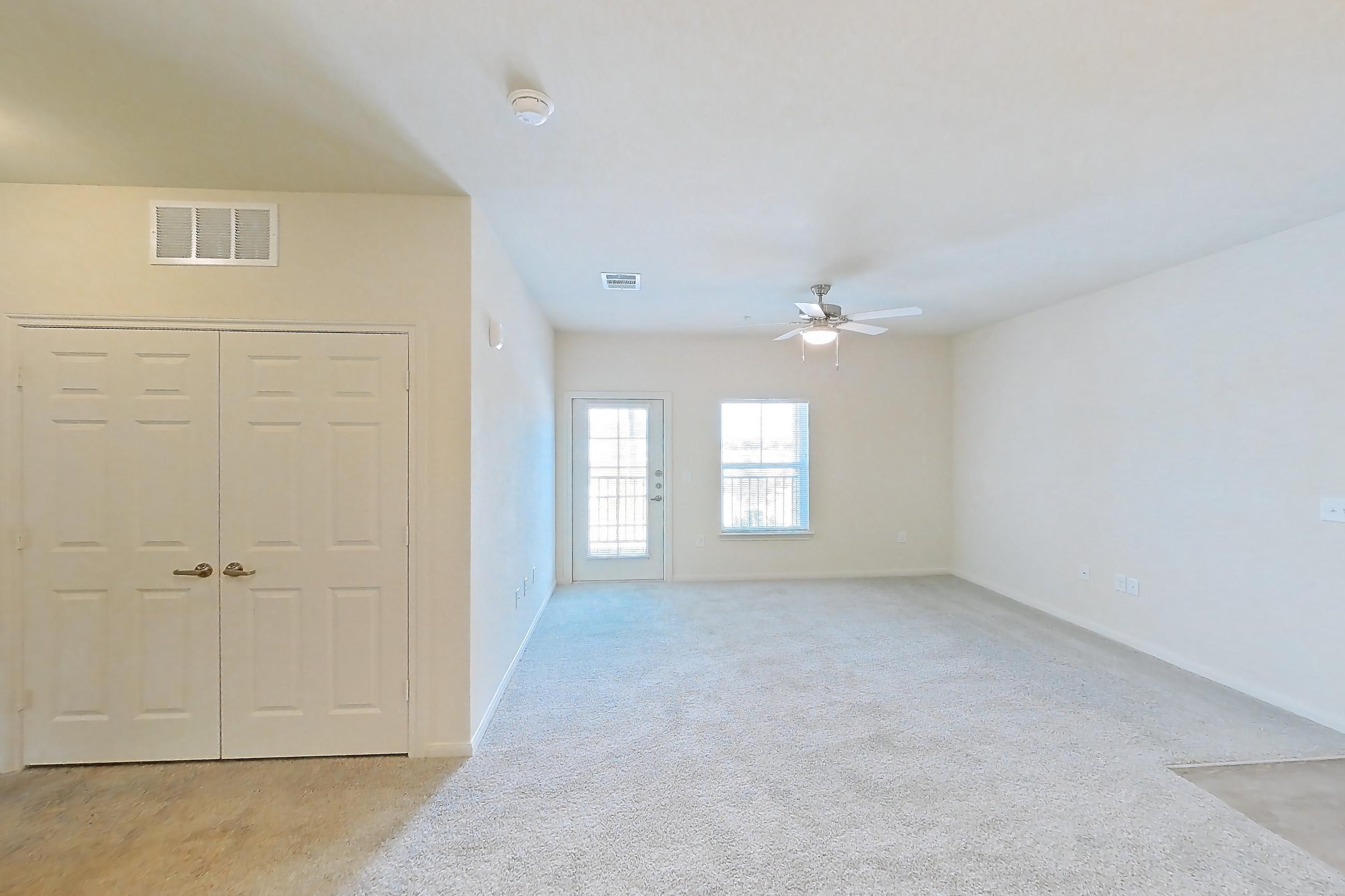 Dining room with black appliances, electric range, light carpet, light countertops, light wood-finish flooring, and oven/range, Apartment 7208 at Mill Stream