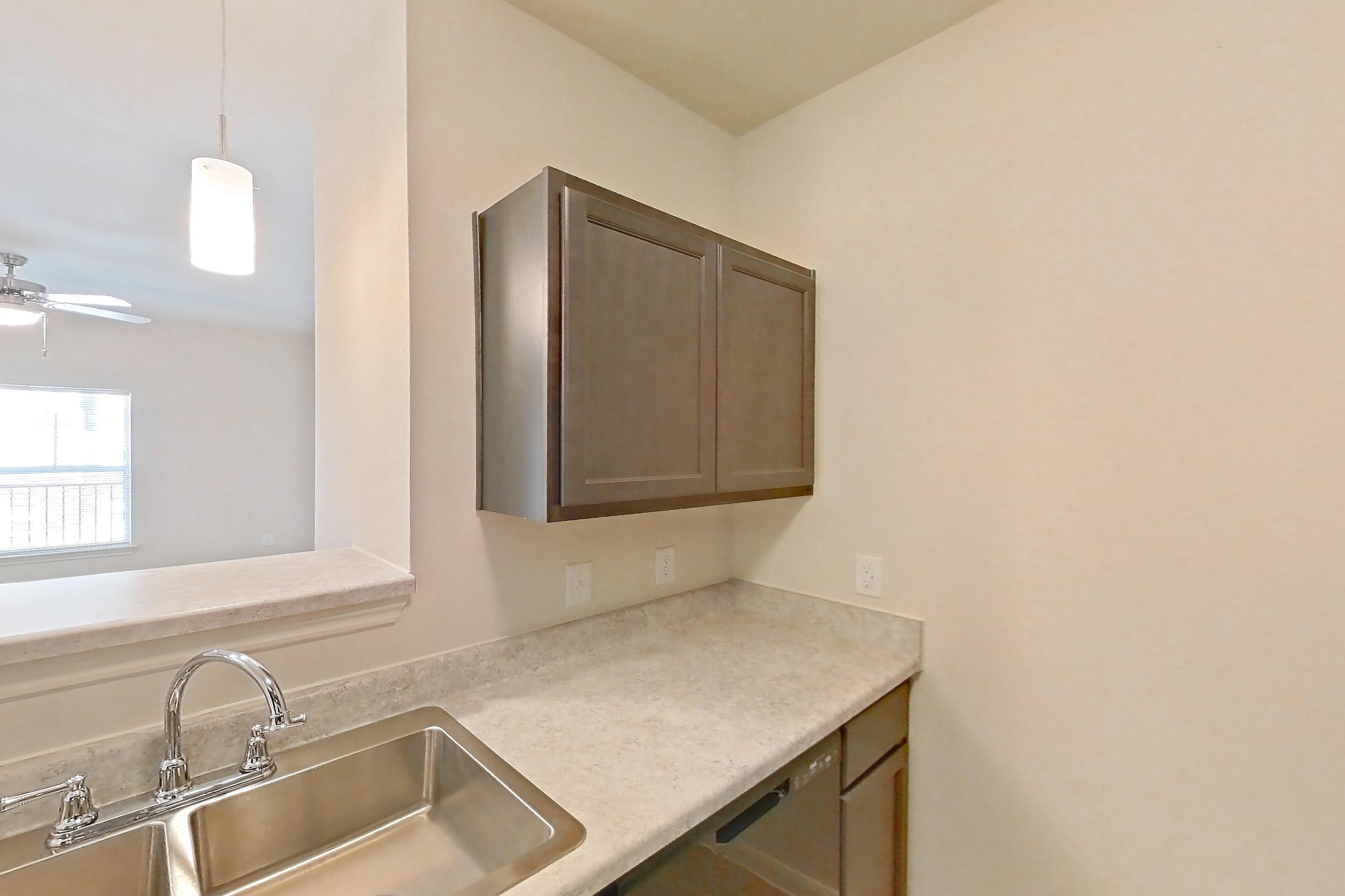 Kitchen with black appliances, dishwasher, electric range, light countertops, light wood-finish flooring, oven/range, and refrigerator, Apartment 7208 at Mill Stream