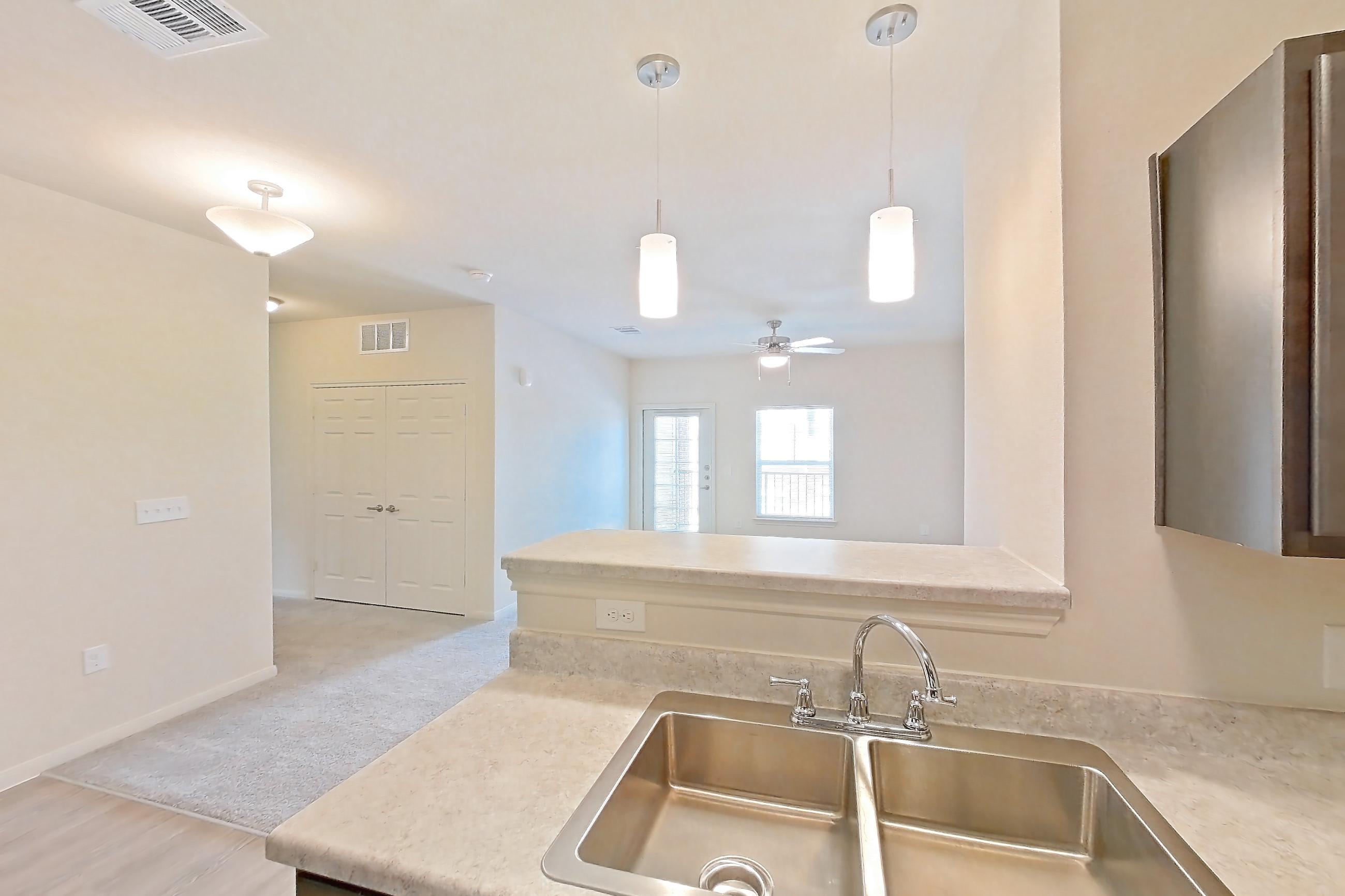 Kitchen with black appliances, dishwasher, electric range, light countertops, light wood-finish flooring, oven/range, and refrigerator, Apartment 7208 at Mill Stream