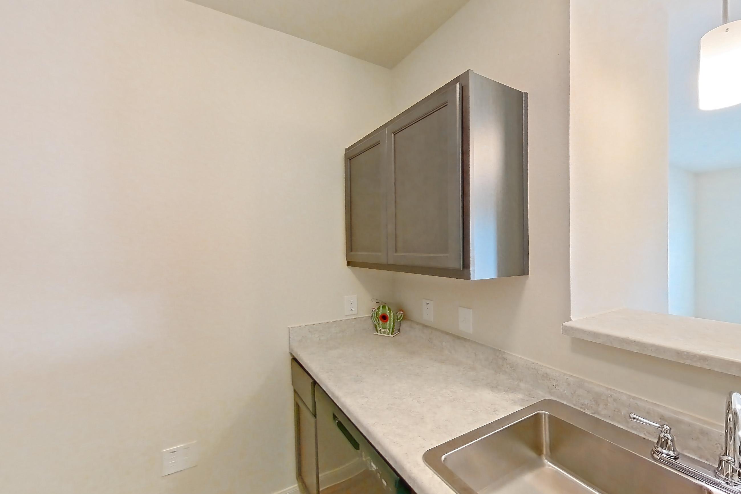 Kitchen with black appliances, dishwasher, electric range, light countertops, light wood-finish flooring, oven/range, refrigerator, and stainless steel appliances, Apartment 3101 at Mill Stream