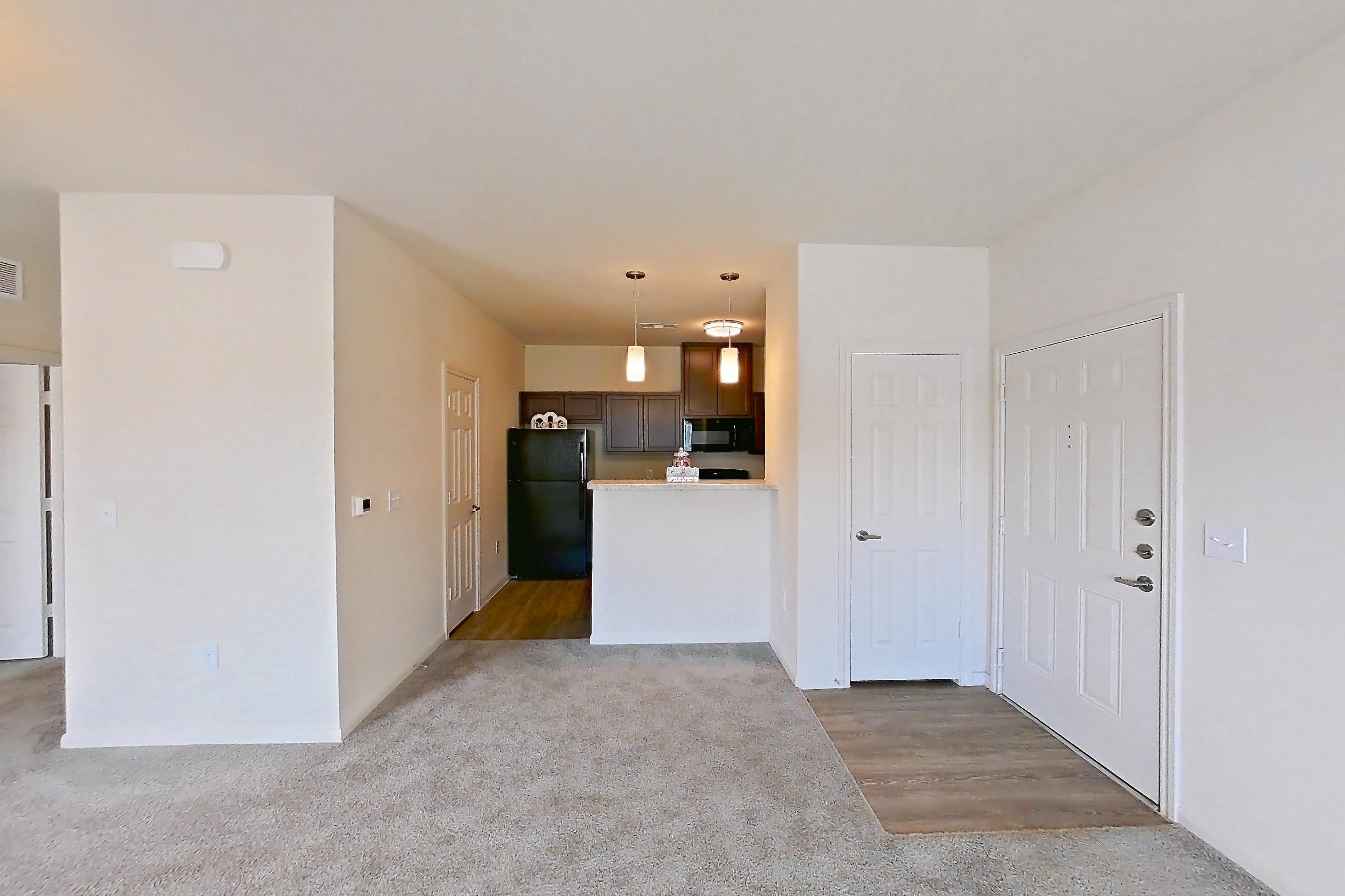 Living room with black appliances and refrigerator, Apartment 3101 at Mill Stream