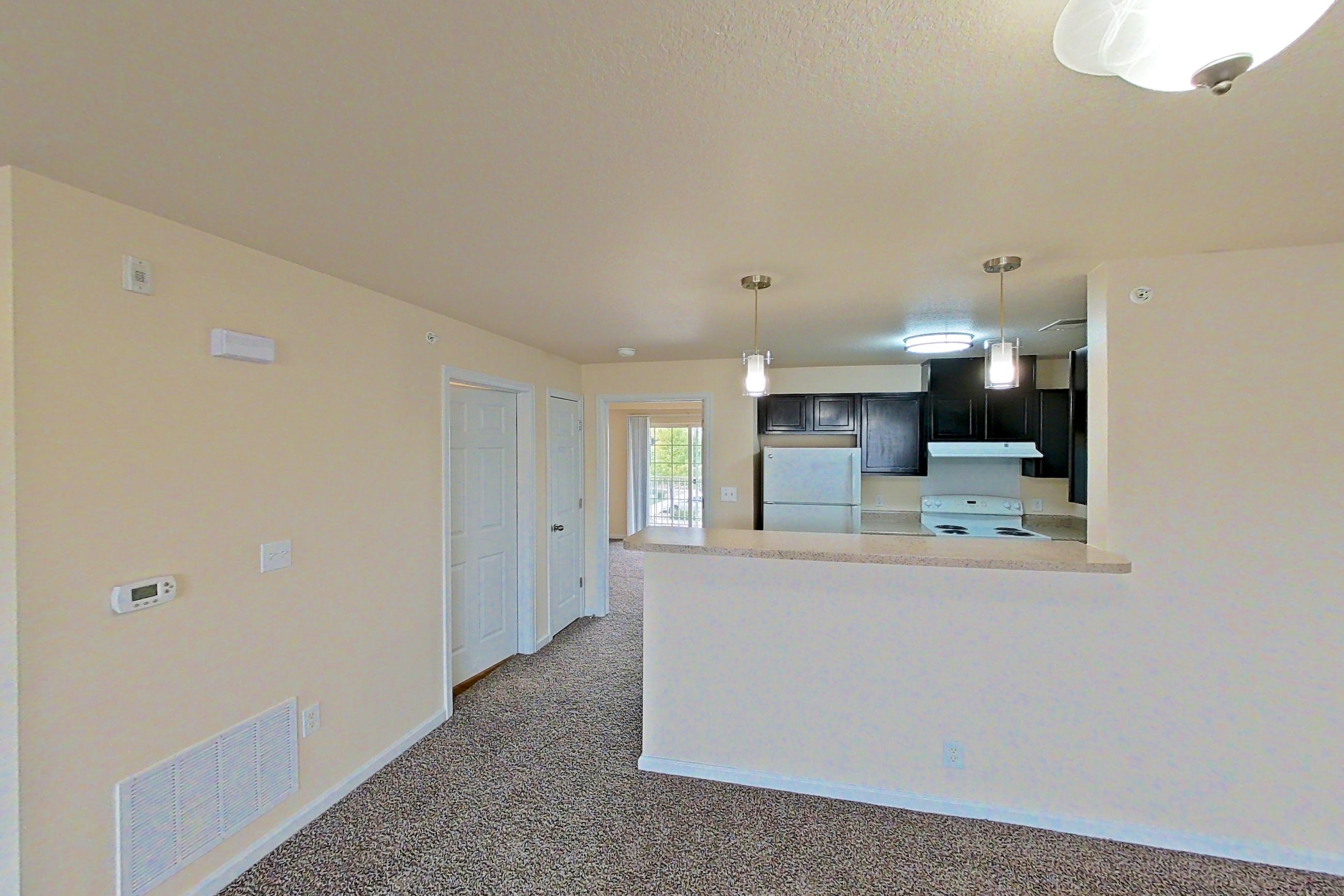 Living space with electric range, oven/range, refrigerator, and white appliances, Apartment 19453 E 57th Ave - Unit 202 at The Meadows at Dunkirk