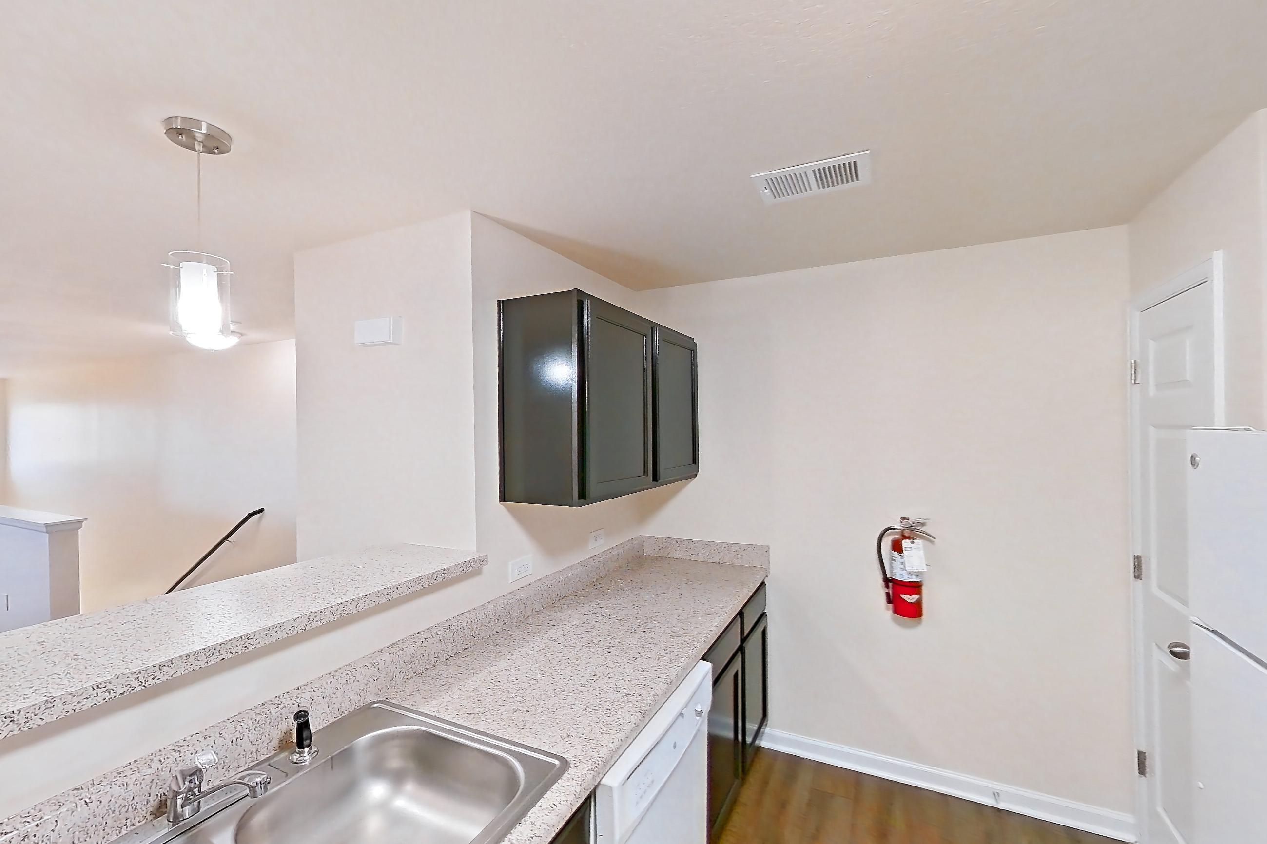 Kitchen with dark carpet, dark wood-finish flooring, dishwasher, electric range, light stone countertops, oven/range, refrigerator, and white appliances, Apartment 19400 E 57th Ave - Unit 204 at The Meadows at Dunkirk