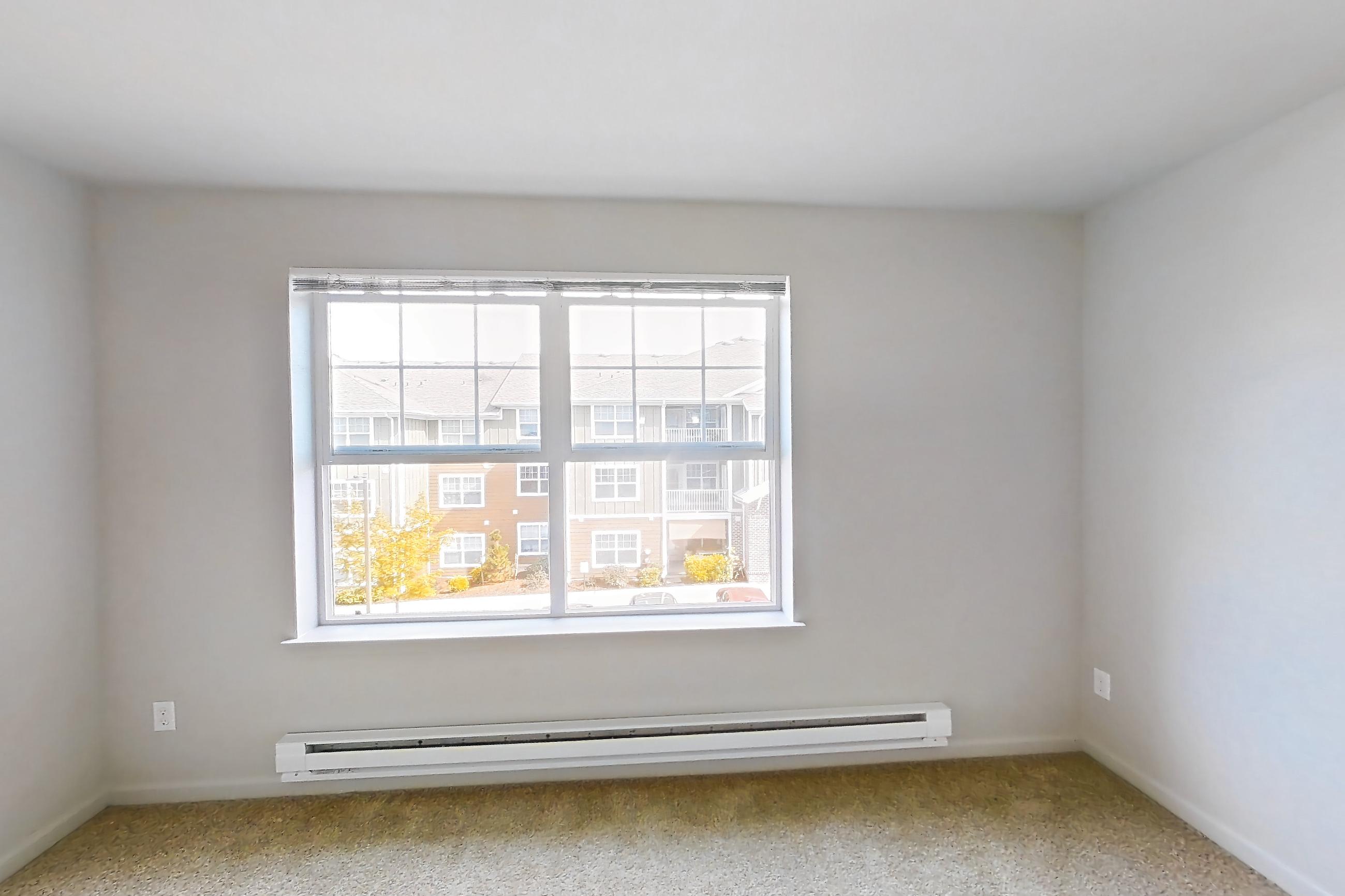 Living room with baseboard heating, Apartment 522 at Sunset View
