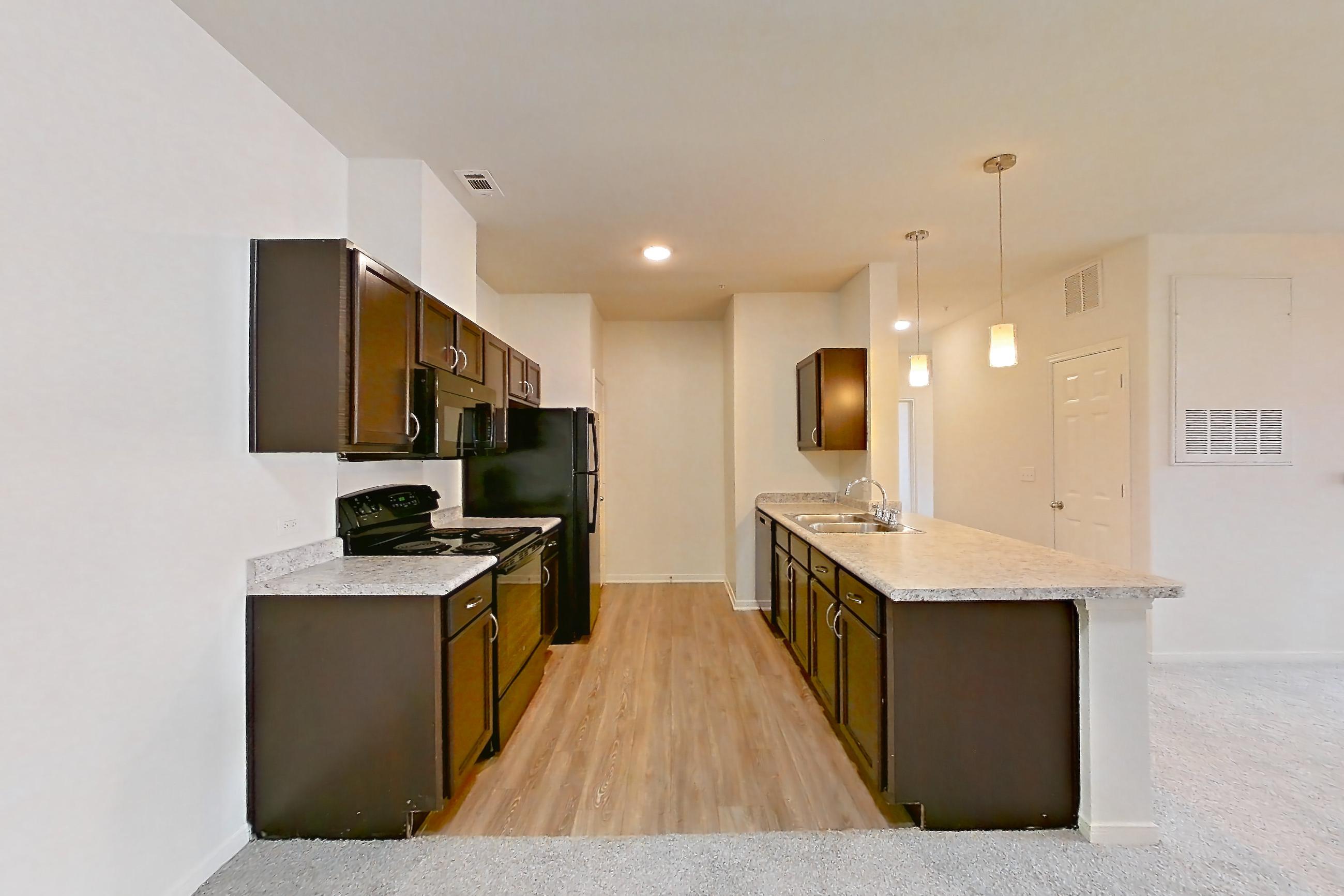 Dining space with black appliances, electric range, light carpet, light countertops, oven/range, and refrigerator, Apartment 913 at Tuckaway