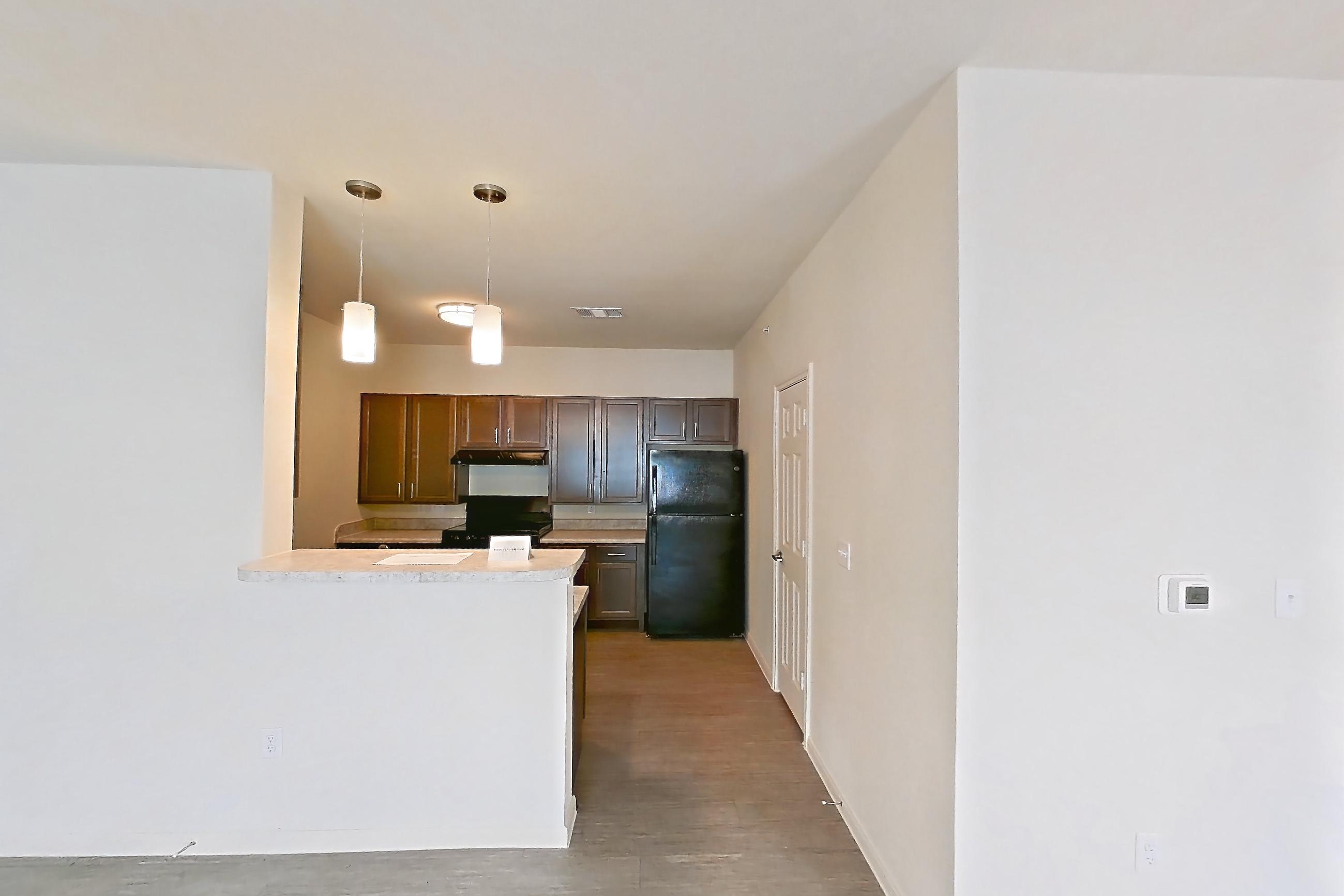 Living room with black appliances, light wood-finish flooring, oven/range, and refrigerator, Apartment 8104 at Denton Grove
