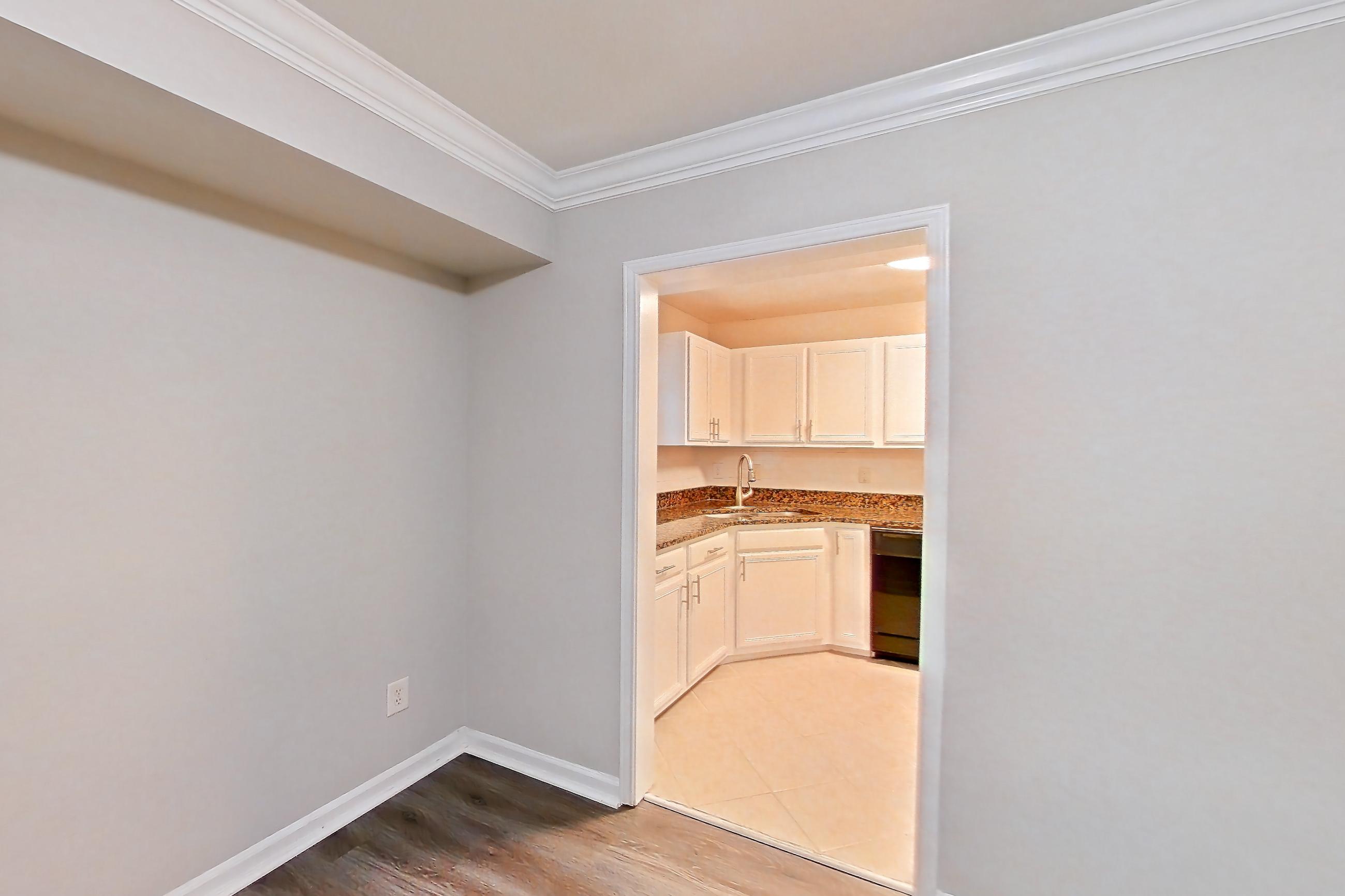Dining room with dark wood-finish flooring, dishwasher, and stainless steel appliances, Apartment 3558Q at The Ashford