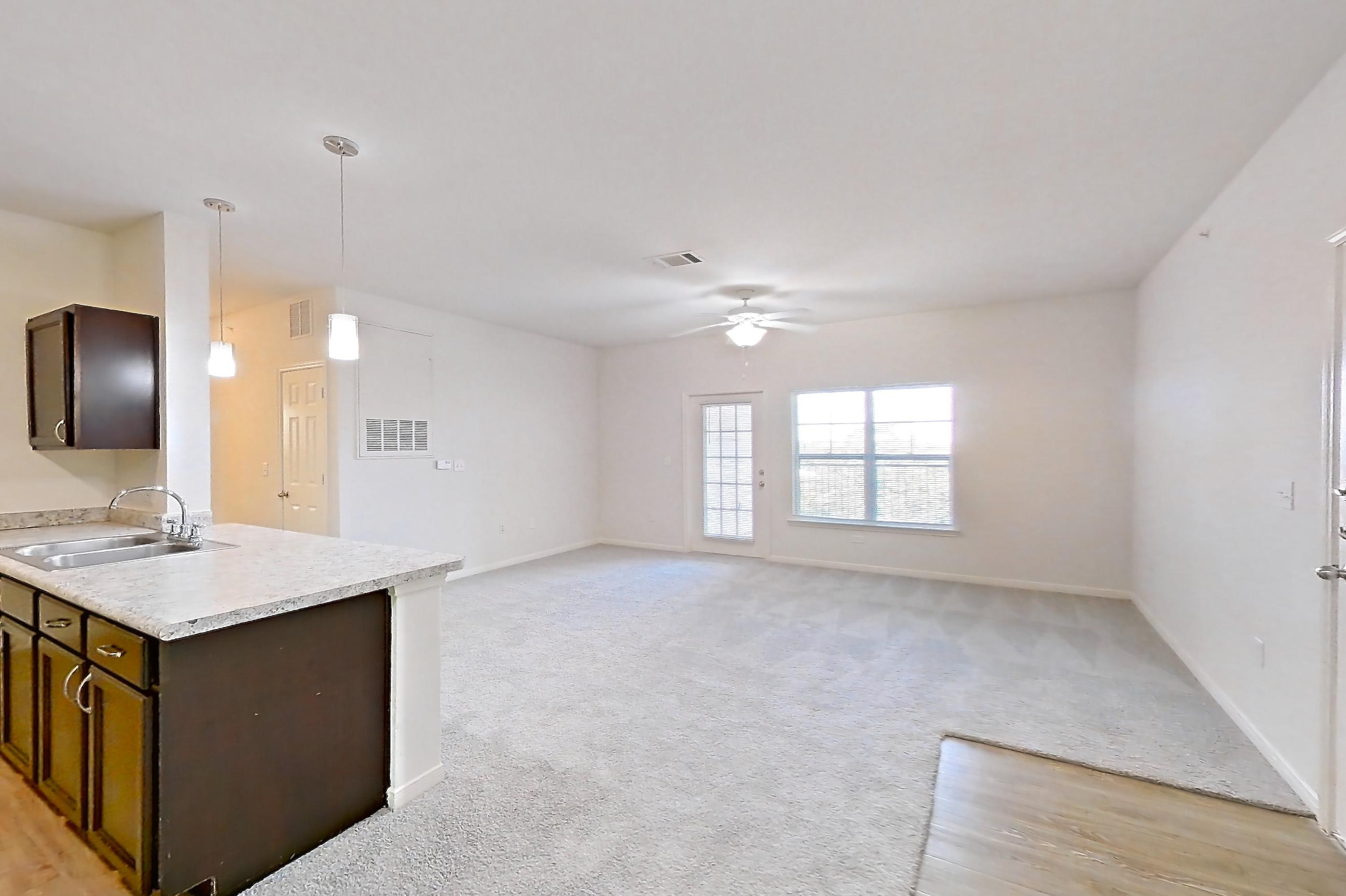 Dining space with black appliances, electric range, light carpet, light countertops, oven/range, and refrigerator, Apartment 632 at Tuckaway