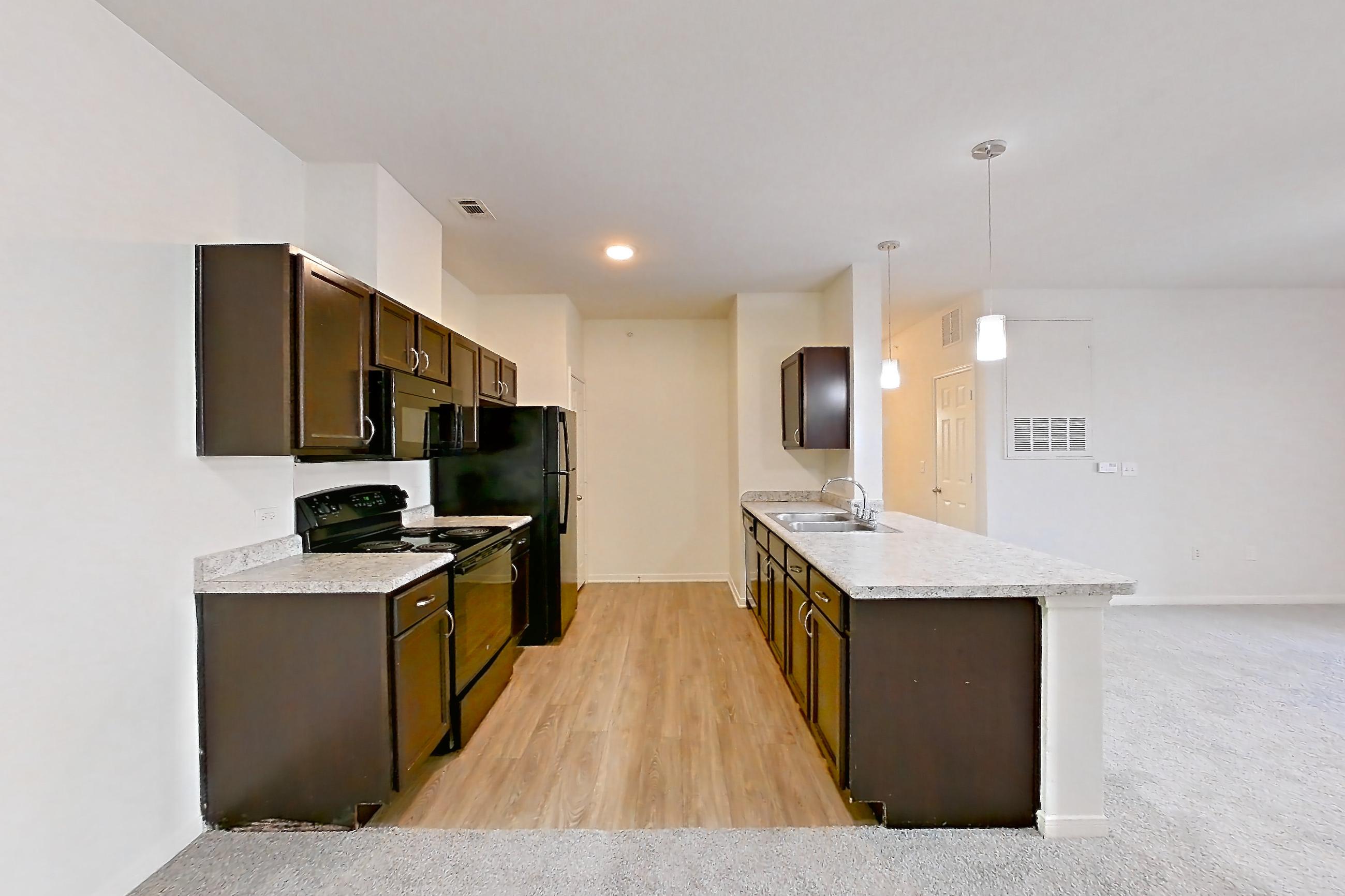 Dining space with black appliances, electric range, light carpet, light countertops, oven/range, and refrigerator, Apartment 632 at Tuckaway