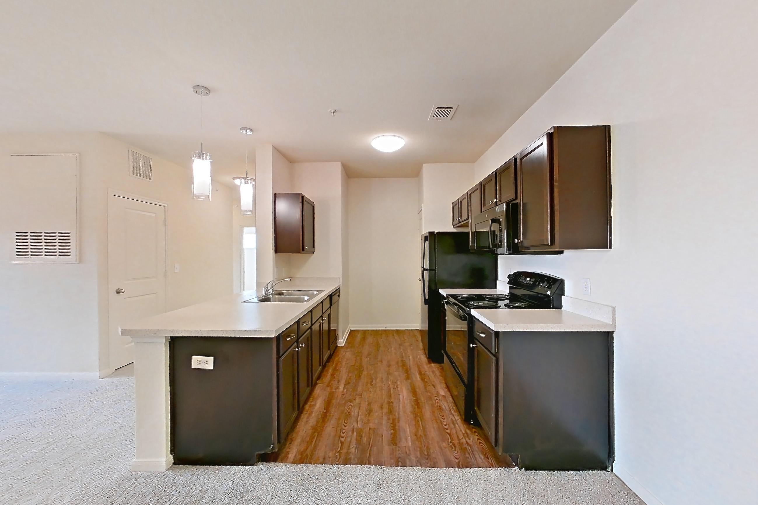 Dining space with black appliances, dark carpet, electric range, light countertops, oven/range, and refrigerator, Apartment 1231 at The Heights on Parmer