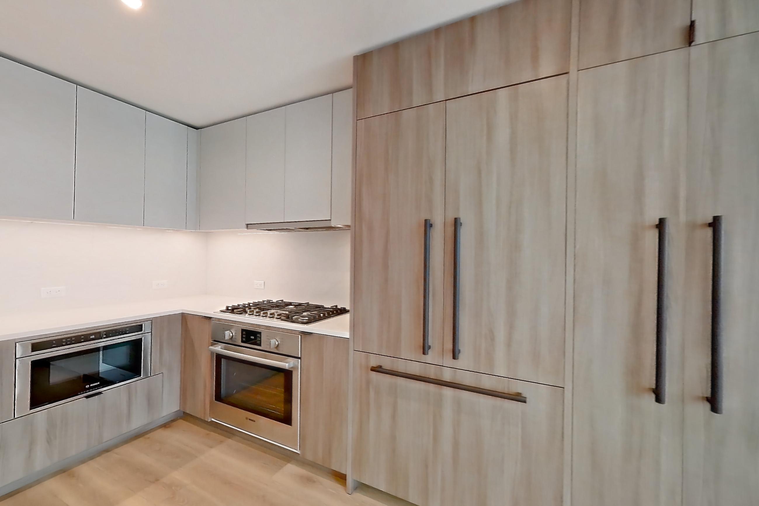Living space with cooktop, gas cooktop, light countertops, light wood-finish flooring, oven/range, and stainless steel appliances, Apartment 12E at Maison 78