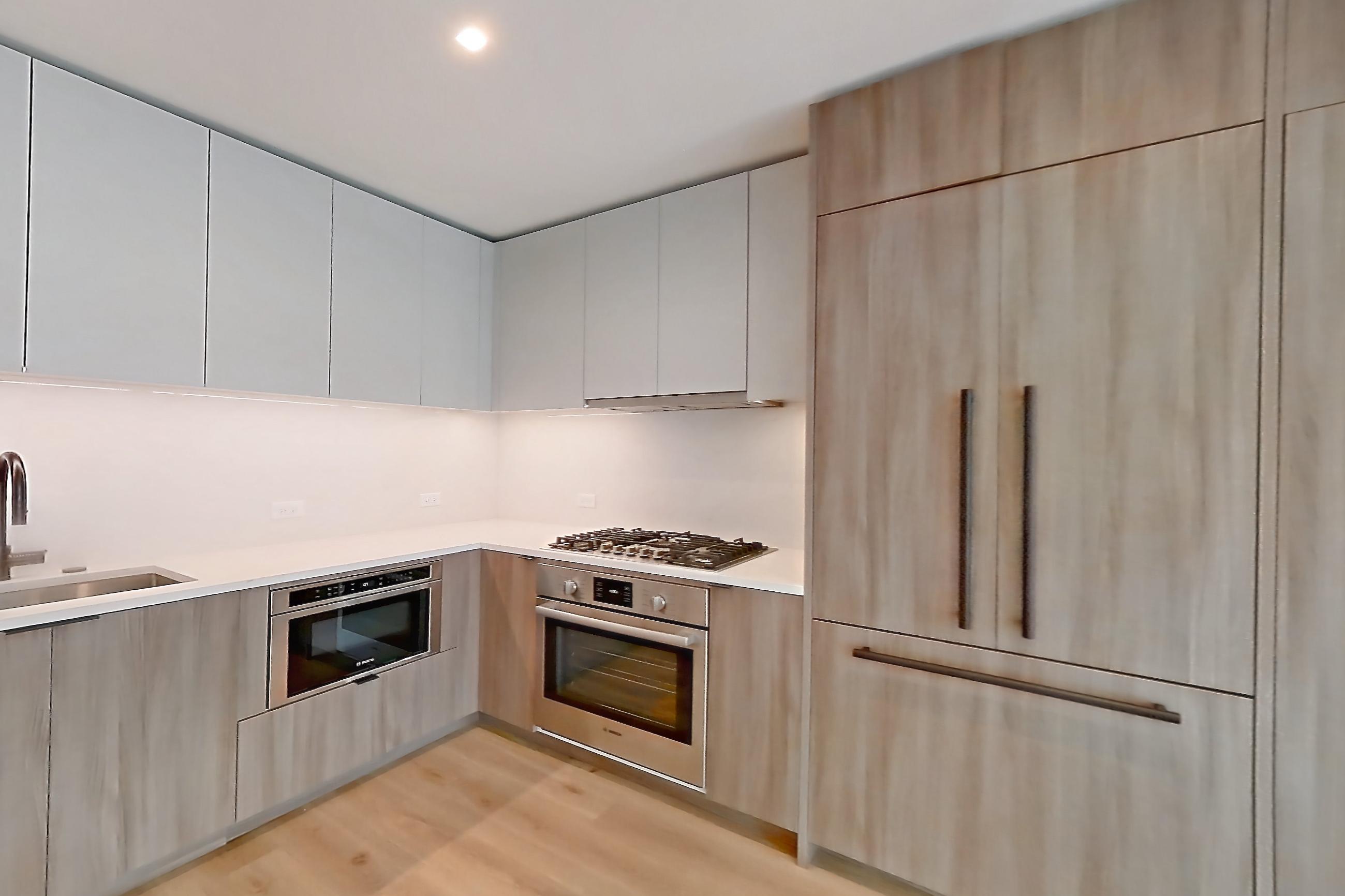 Living space with cooktop, gas cooktop, light countertops, light wood-finish flooring, oven/range, and stainless steel appliances, Apartment 13E at Maison 78