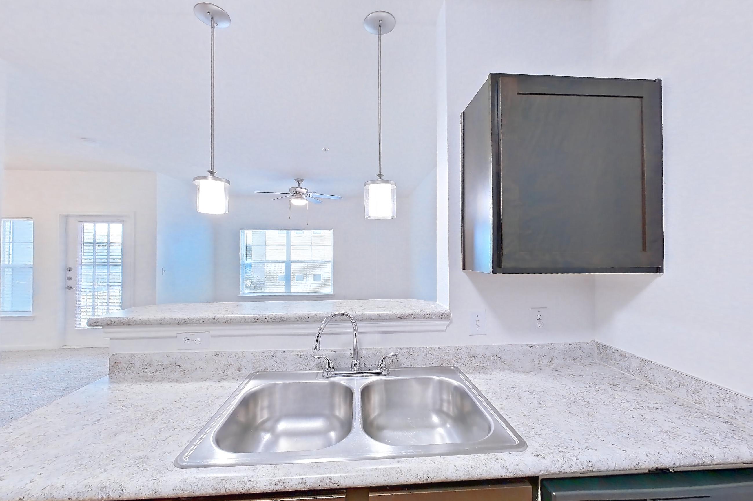 Kitchen with black appliances, dishwasher, electric range, light stone countertops, light wood-finish flooring, oven/range, and refrigerator, Apartment 1202 at Oak Valley