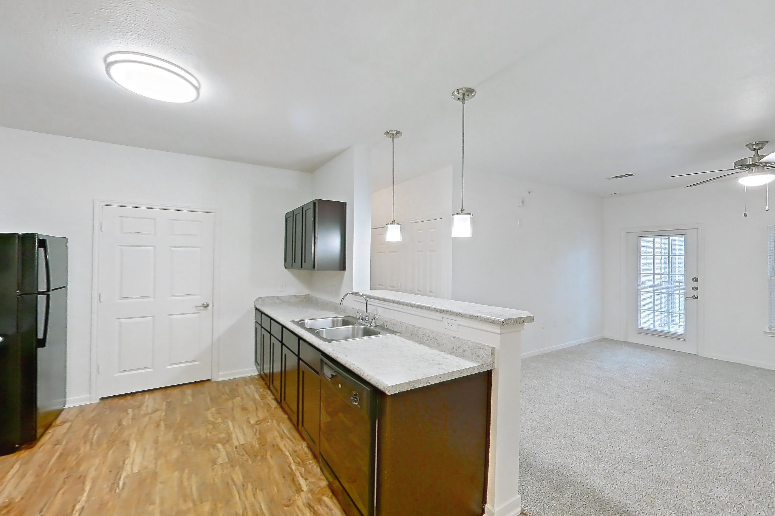 Dining room with black appliances, dishwasher, electric range, light countertops, light wood-finish flooring, oven/range, and refrigerator, Apartment 7202 at Oak Valley