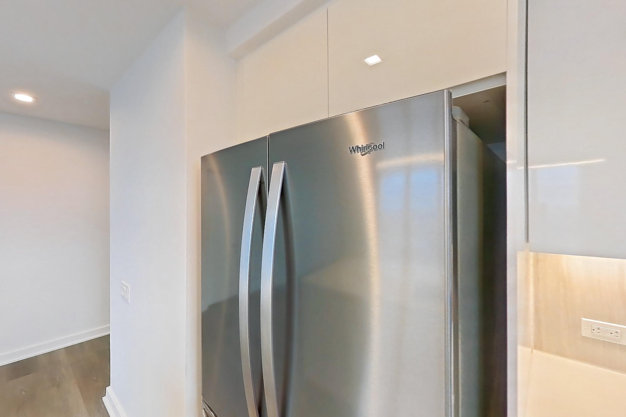 Kitchen with dishwasher, gas range, light countertops, light wood-finish flooring, oven/range, refrigerator, and stainless steel appliances, Apartment Ph2B at Alta+