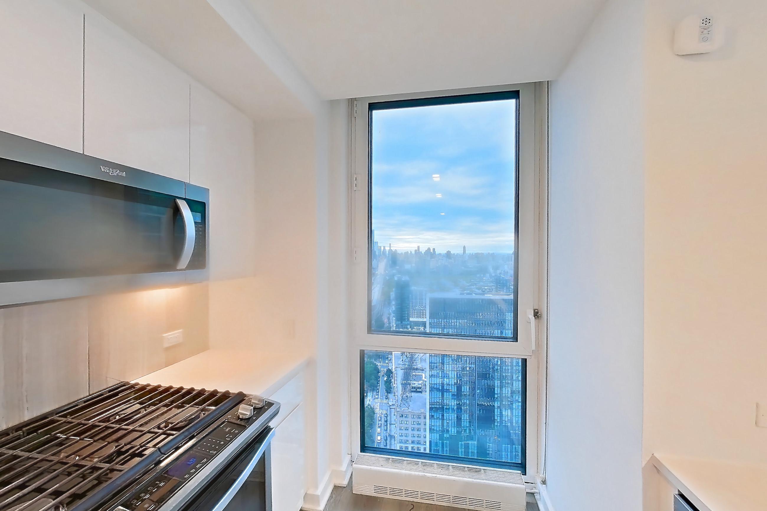 Kitchen with dishwasher, gas range, light countertops, light wood-finish flooring, oven/range, refrigerator, and stainless steel appliances, Apartment Ph2B at Alta+
