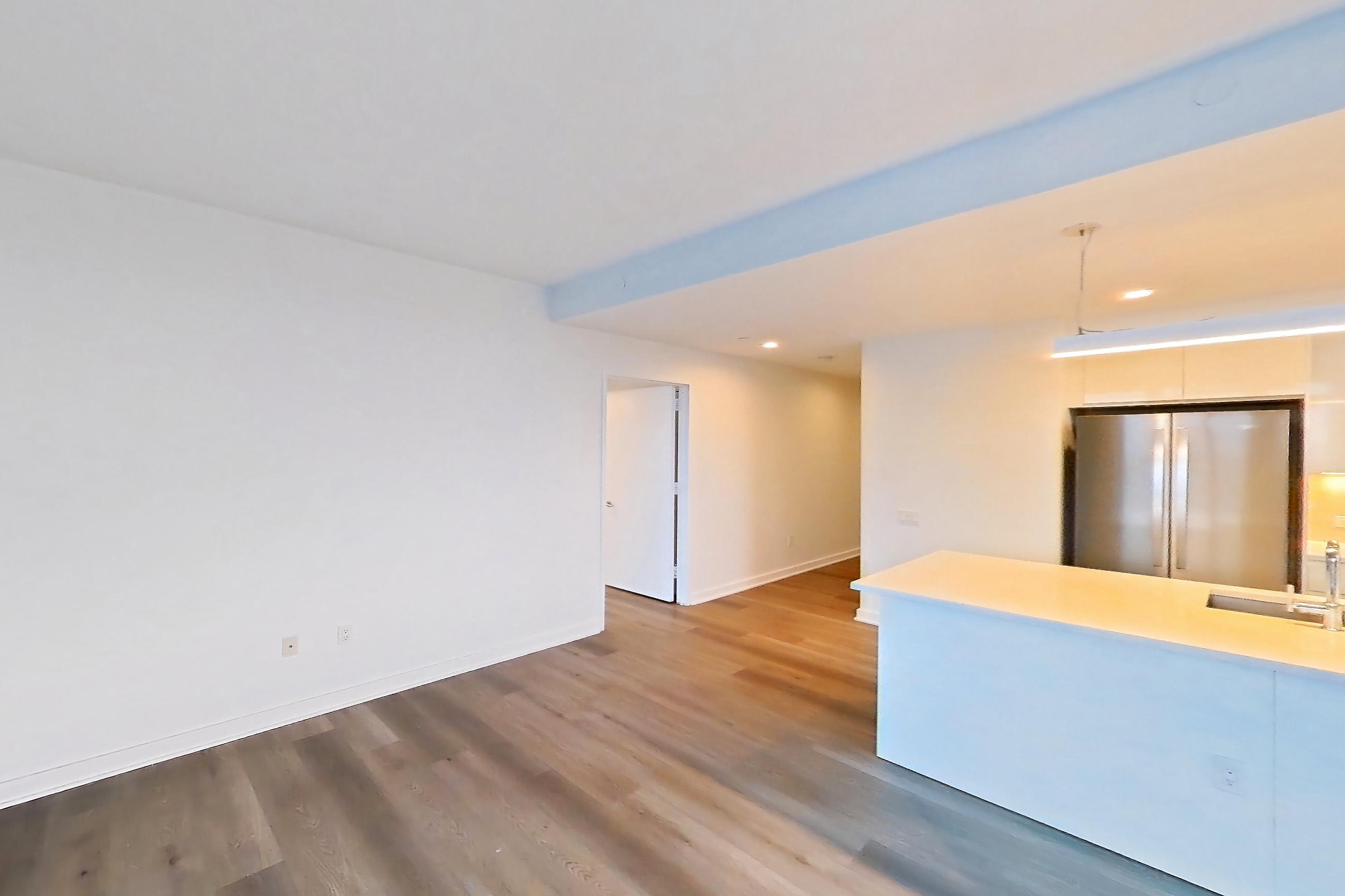 Living space with city view, light countertops, and light wood-finish flooring, Apartment Ph2B at Alta+
