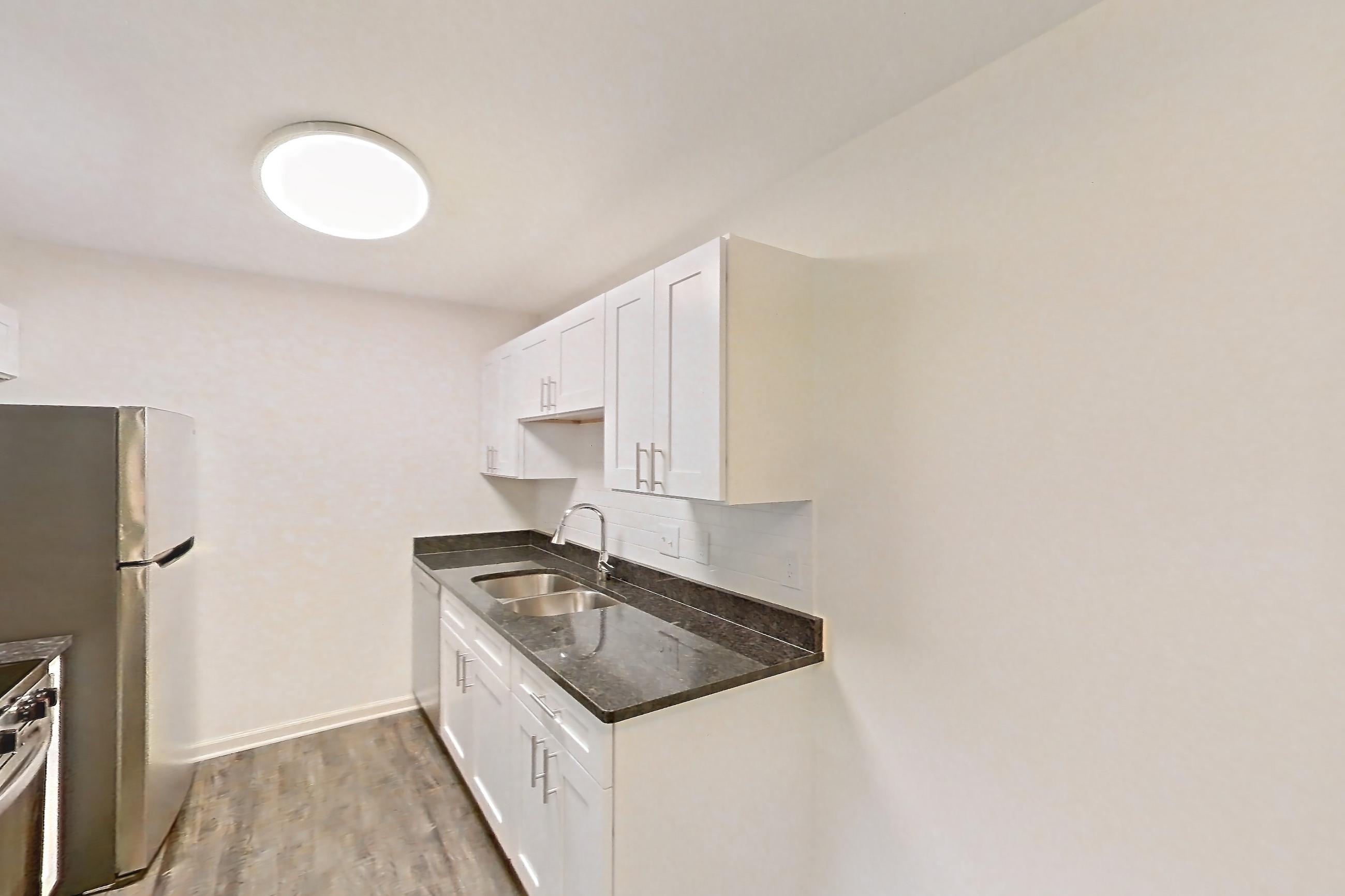 Dining room with dark carpet, dark stone countertops, dark wood-finish flooring, dishwasher, electric range, light countertops, oven/range, refrigerator, stainless steel appliances, and white appliances, Apartment 68108 at The Boulders