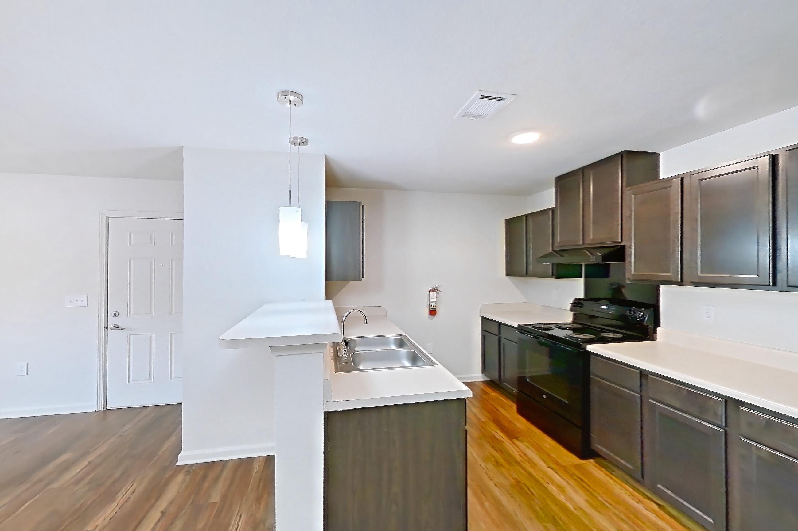 Dining room with black appliances, dark wood-finish flooring, electric range, light countertops, oven/range, and refrigerator, Apartment 8223 Unit 108 at The HUB on Harris