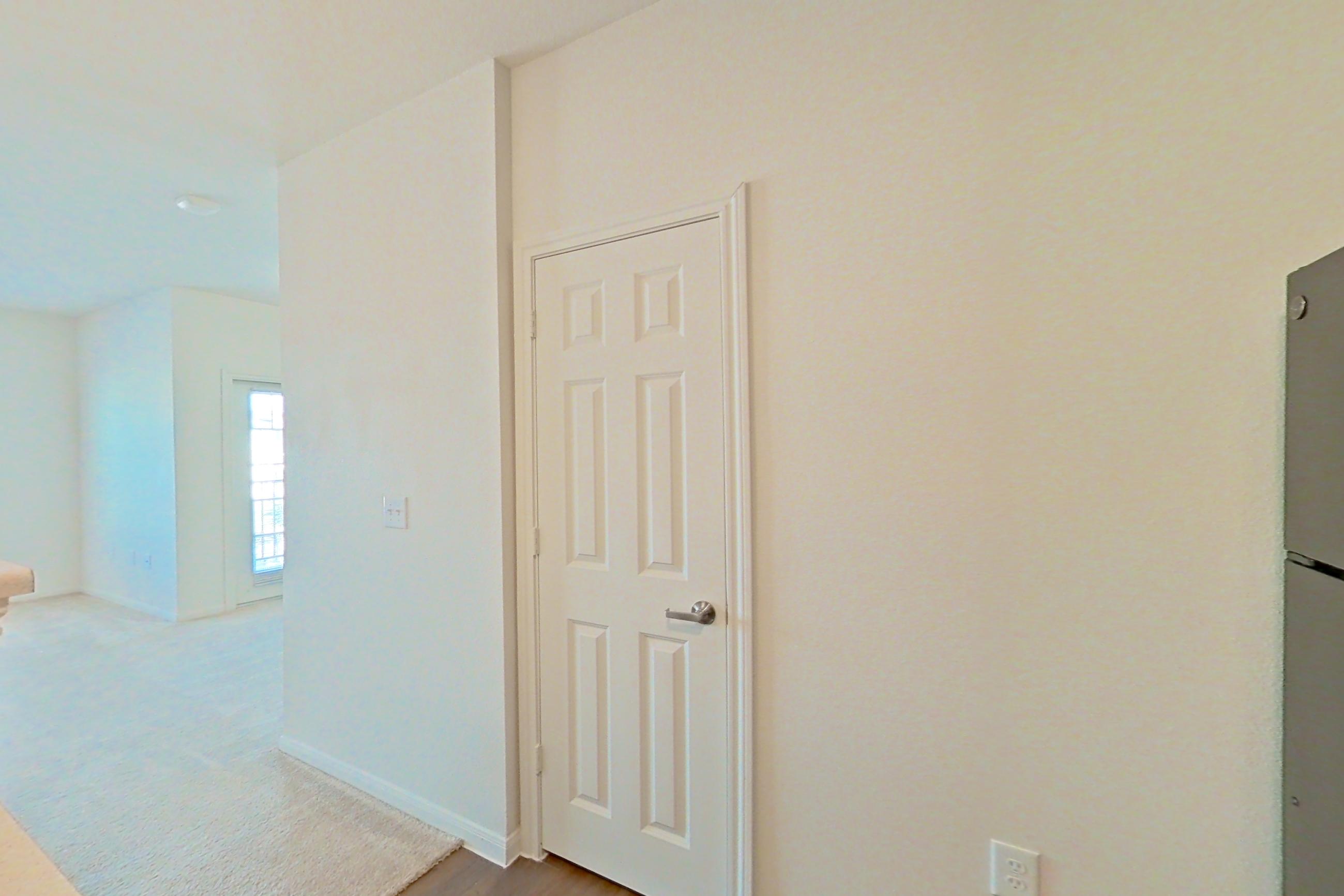 Kitchen with black appliances, dishwasher, electric range, light countertops, light wood-finish flooring, oven/range, refrigerator, and stainless steel appliances, Apartment 9301 at Canyon Pass