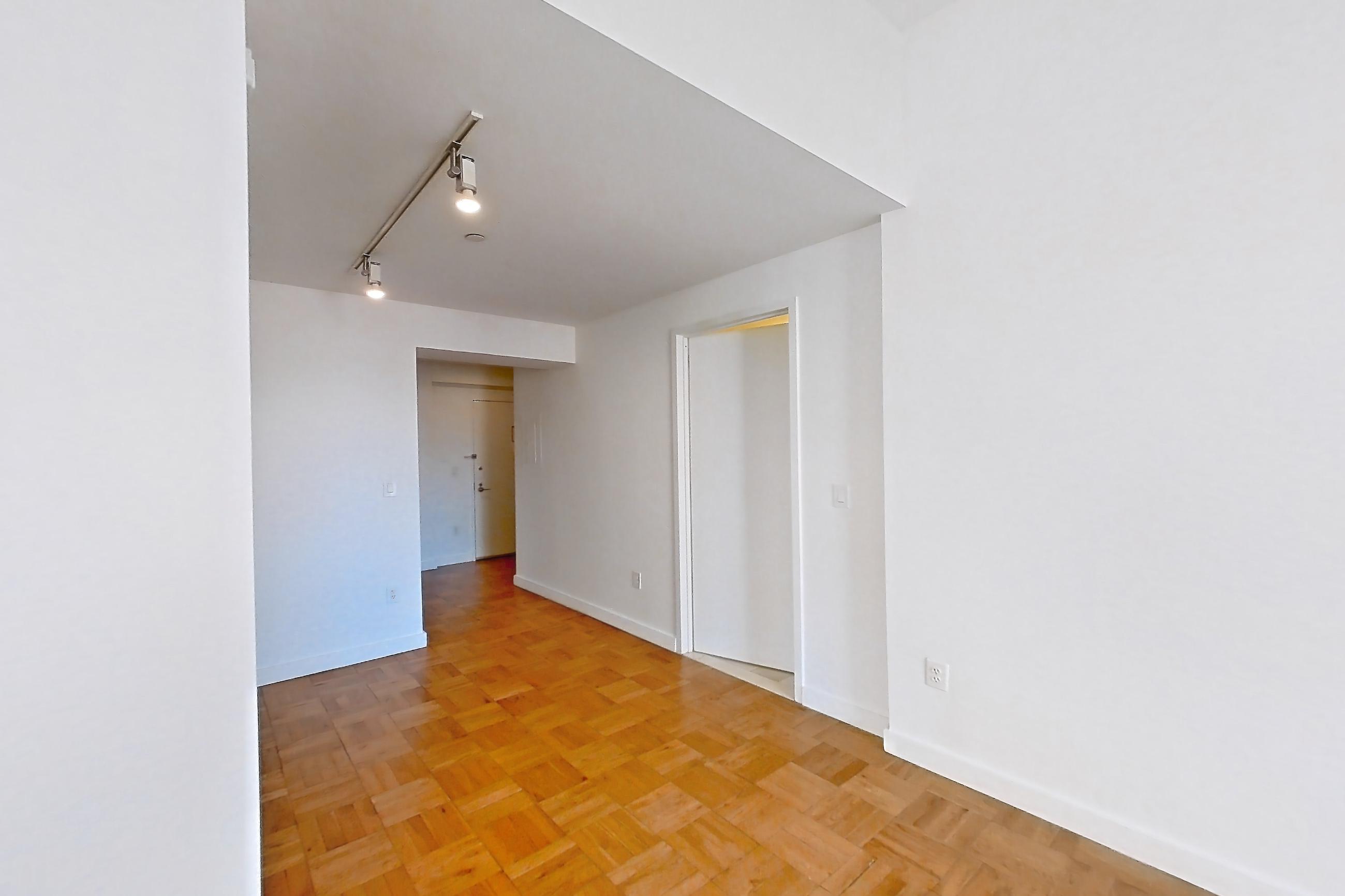 Living space with light wood-finish flooring and parquet flooring, Apartment 2906 at 20 Exchange Place