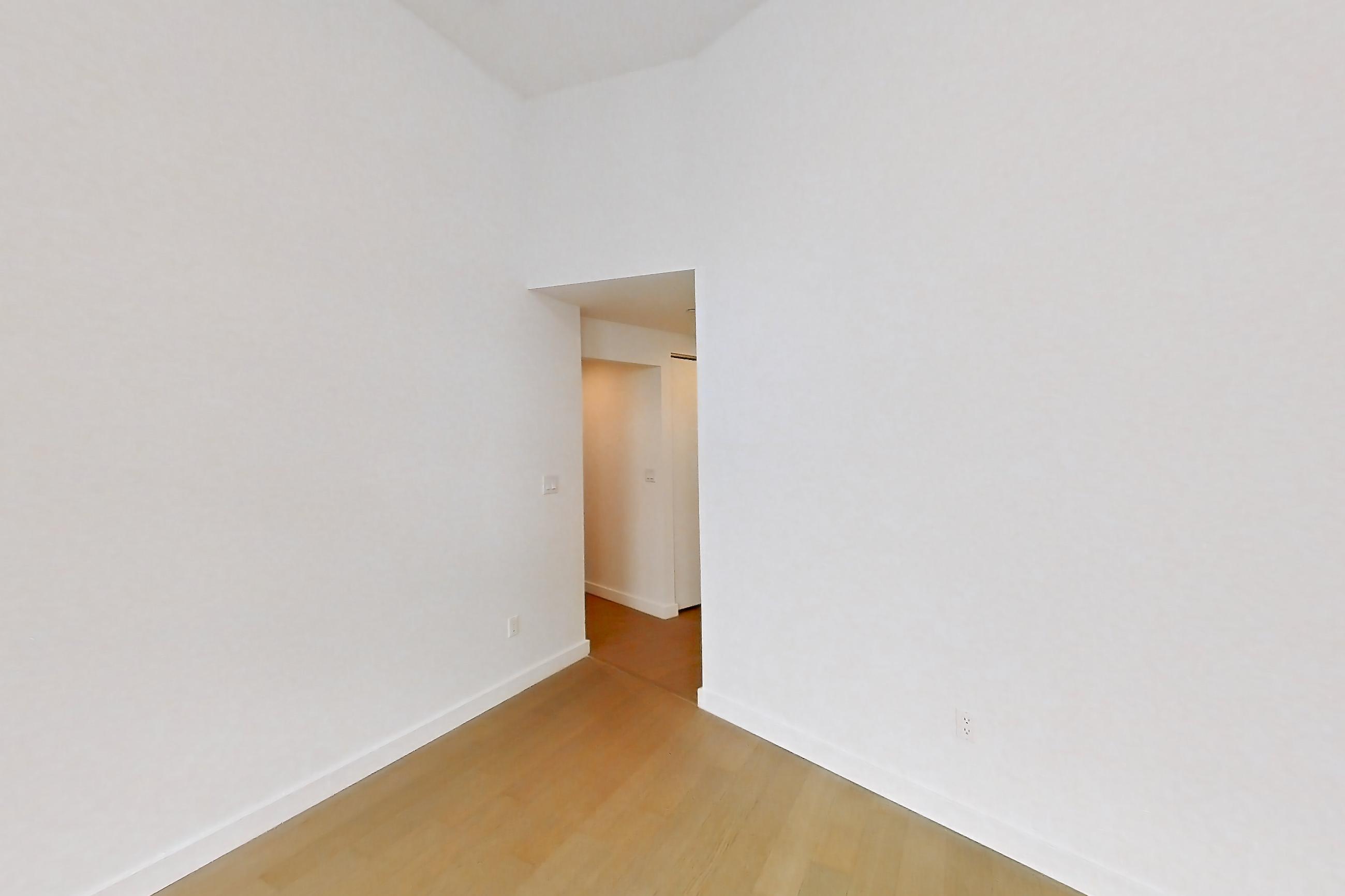 Living space with light wood-finish flooring, Apartment 1503 at 20 Exchange Place