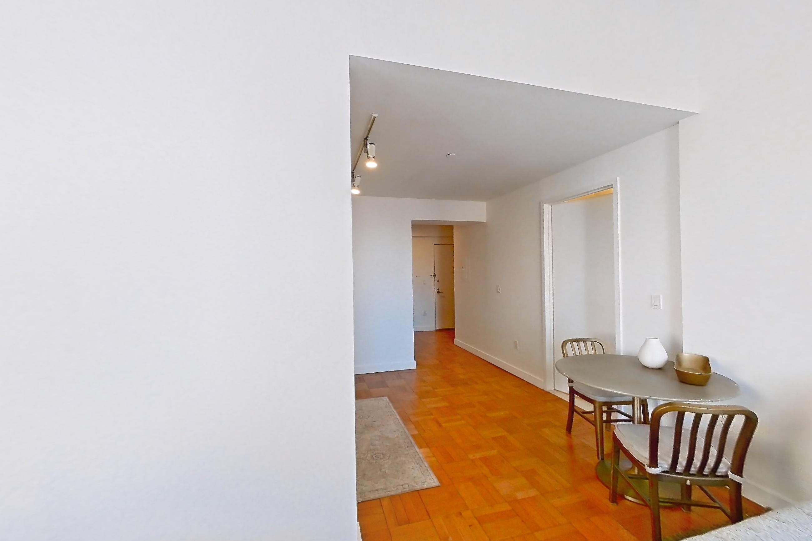 Living space with light wood-finish flooring and parquet flooring, Apartment 3006 at 20 Exchange Place