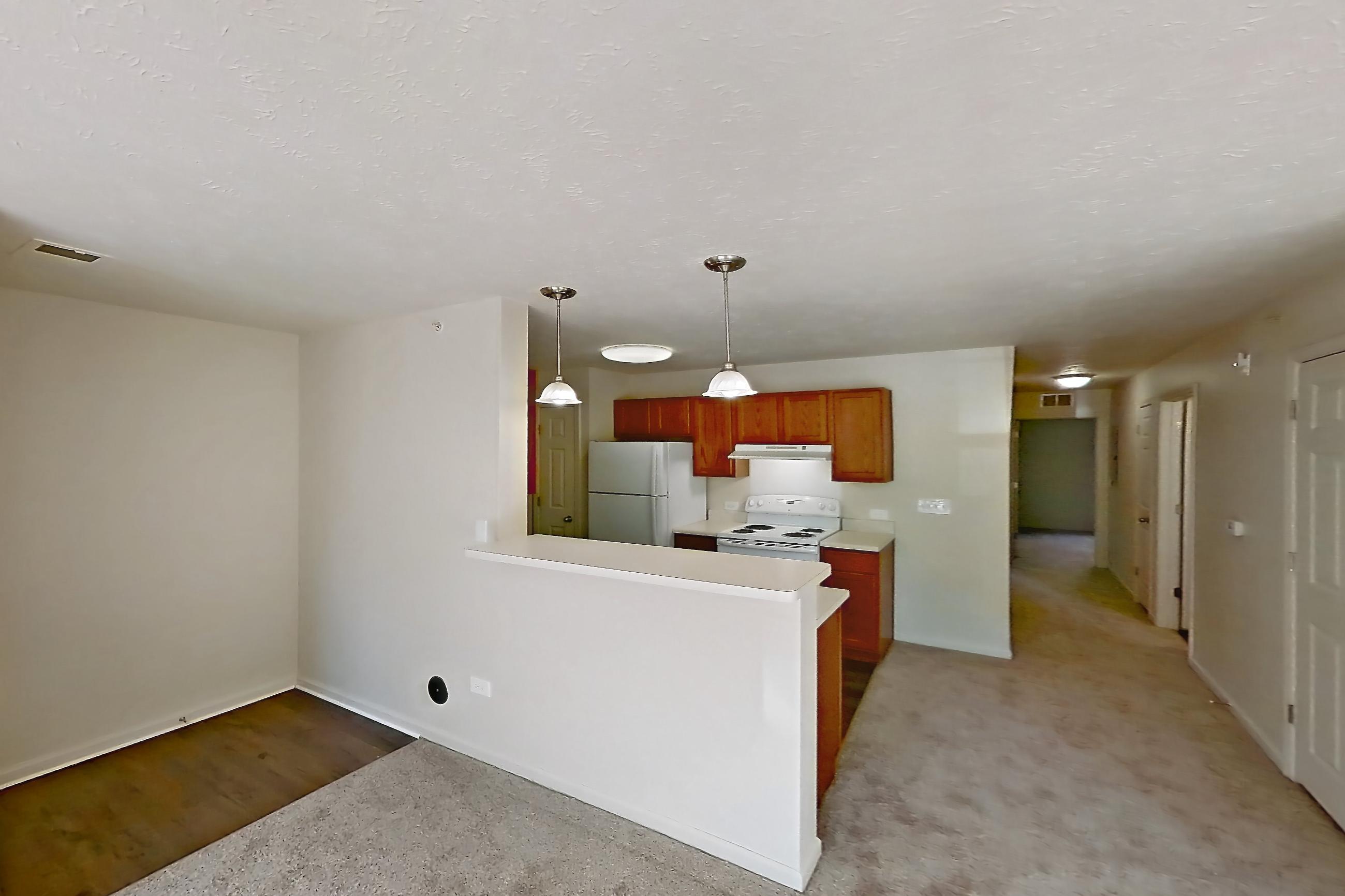 Living room with electric range, light carpet, oven/range, refrigerator, and white appliances, Apartment 412 at Village Park