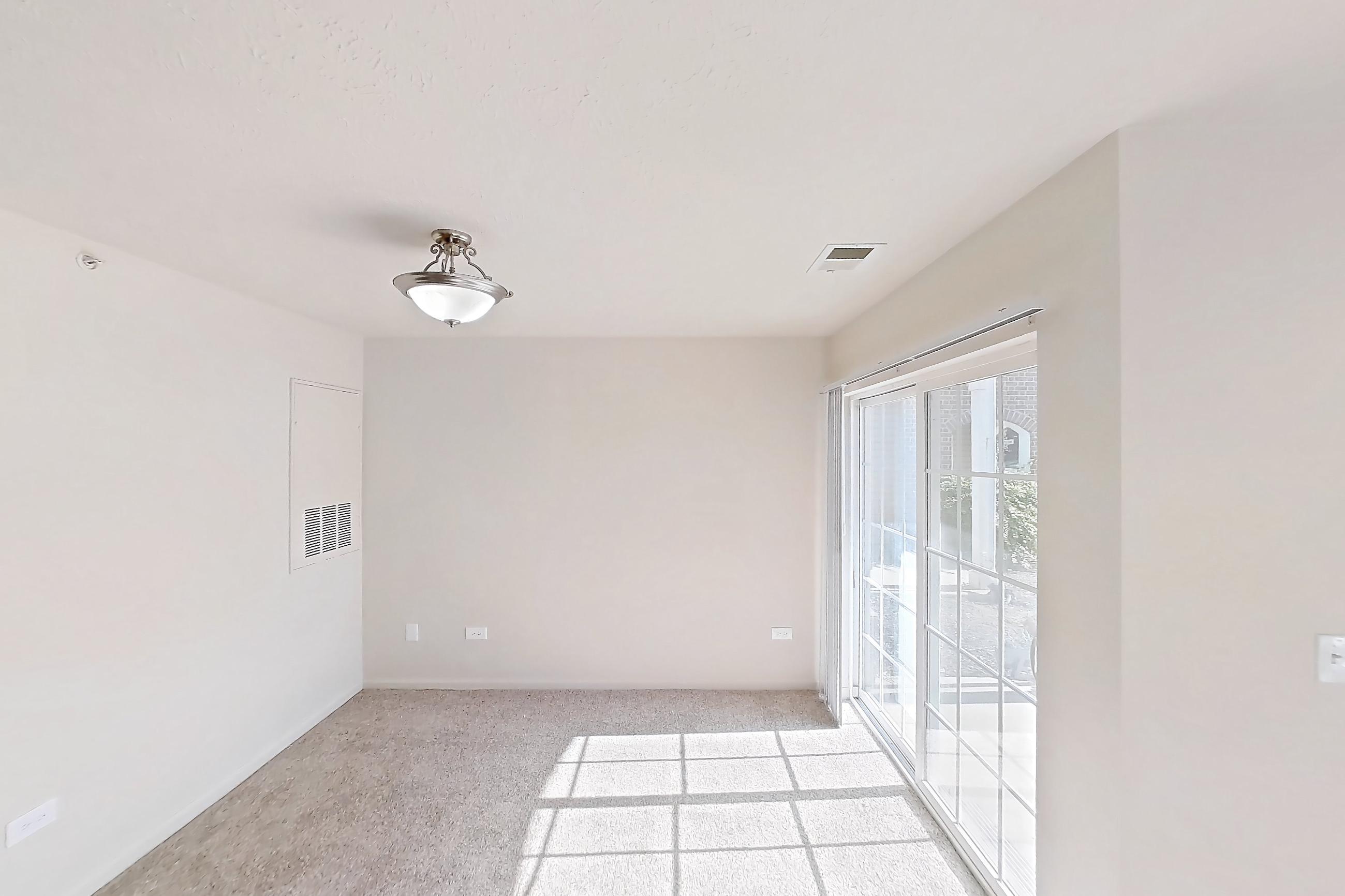 Living room with electric range, light carpet, oven/range, refrigerator, and white appliances, Apartment 412 at Village Park